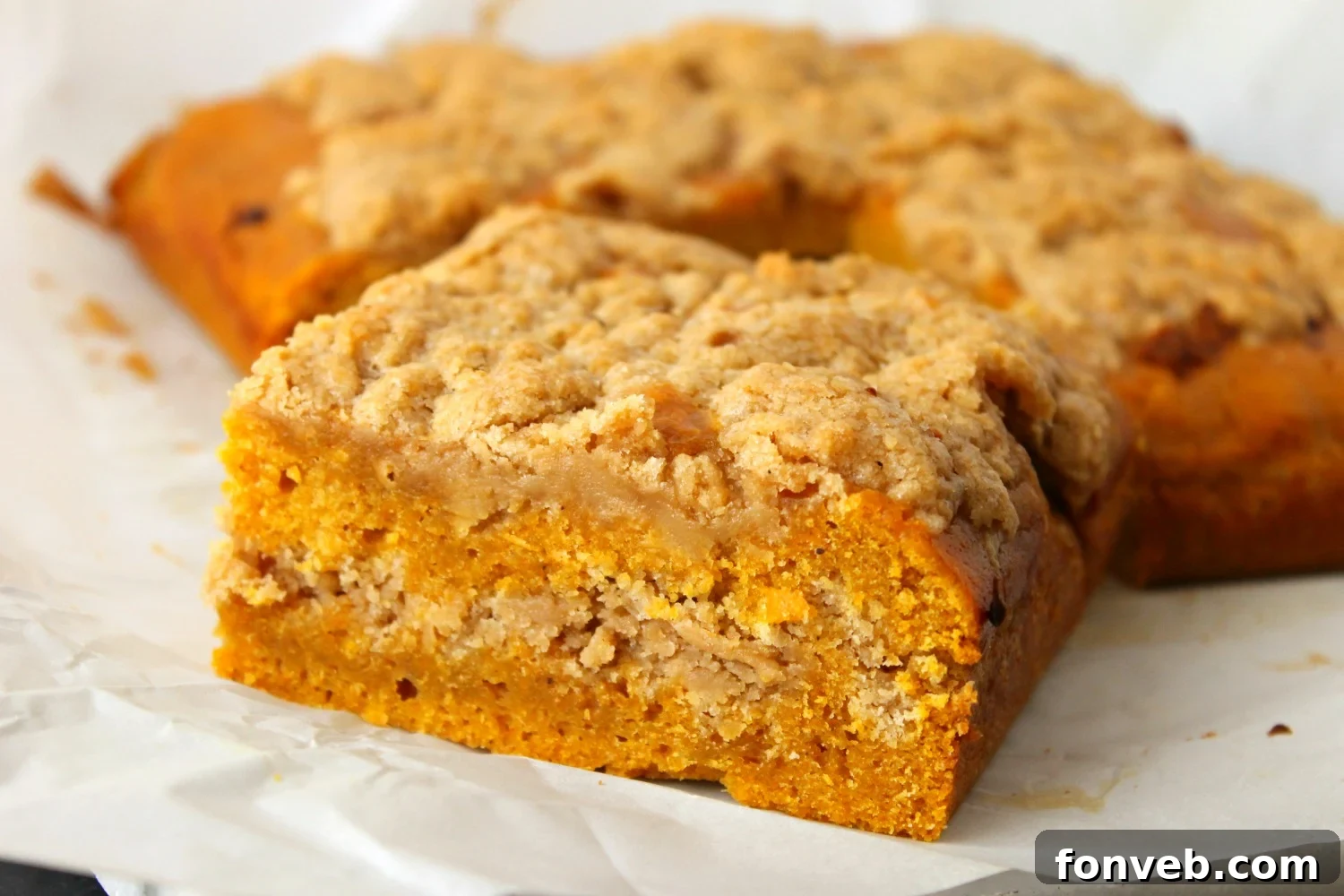 Deliciously moist pumpkin coffee cake with a generous streusel topping, ready to be served
