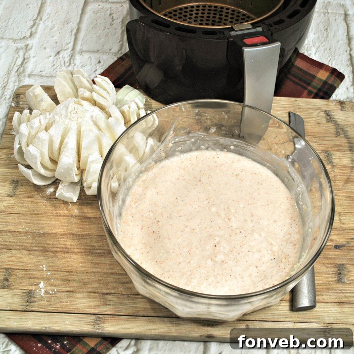 A close-up view of a Vidalia onion expertly cut into its characteristic blooming flower shape, with petals fanned out.