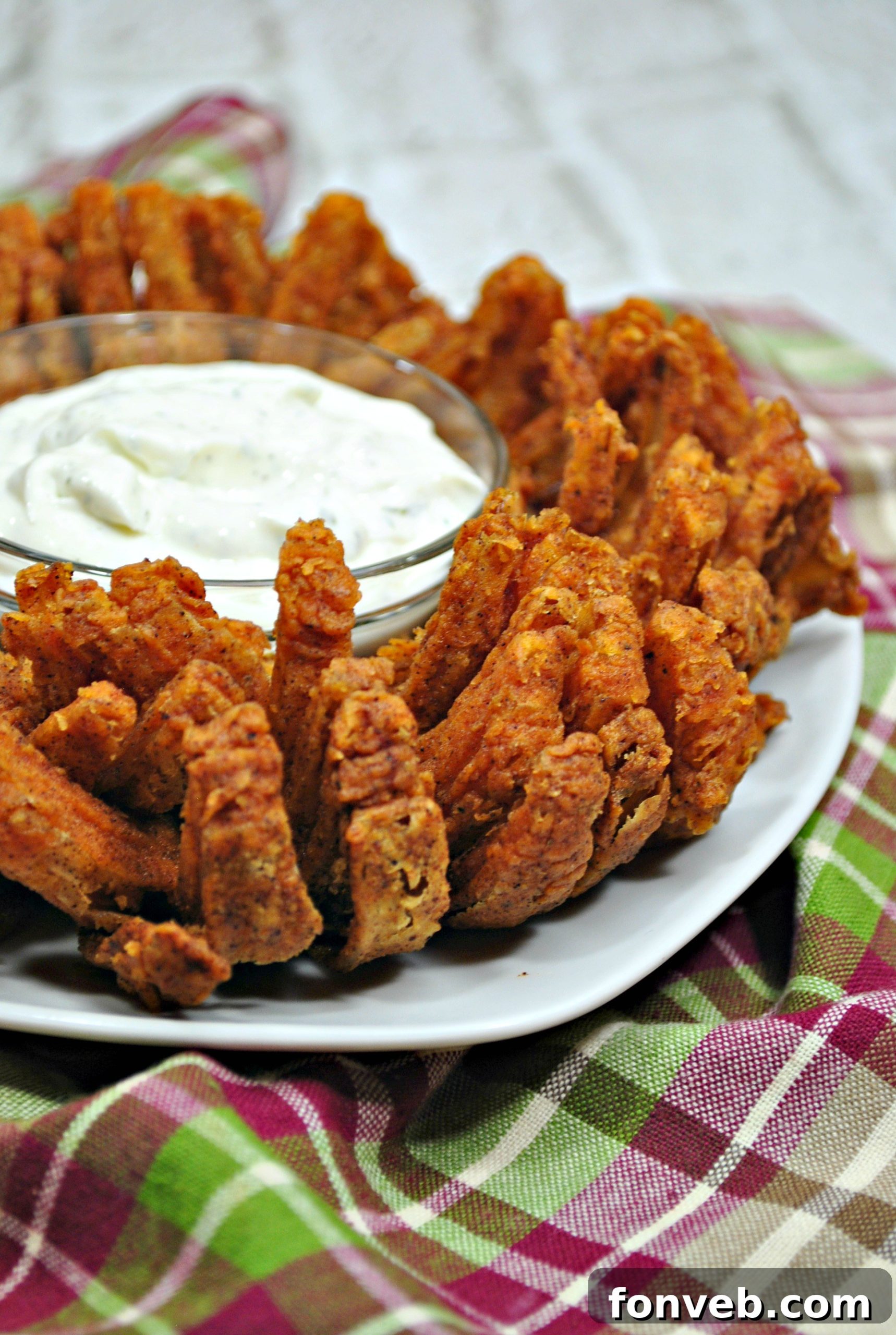 A perfectly coated Bloomin' Onion, showcasing its thick, even layer of spiced batter, ready for air frying and ultimate crispness.