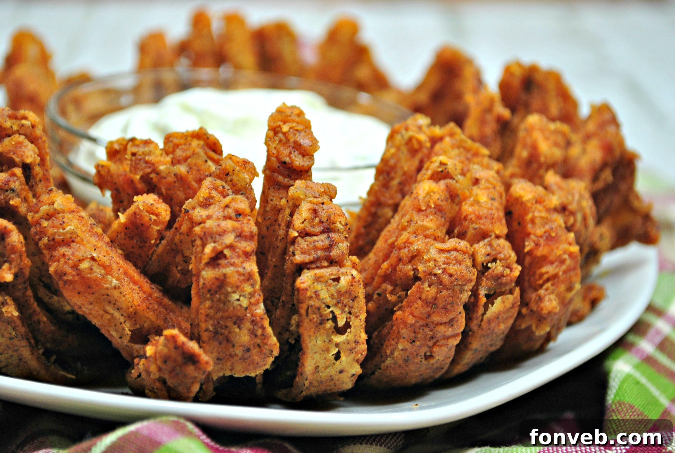 The golden-brown, crispy Bloomin' Onion just out of the air fryer, looking absolutely irresistible and ready to be served.