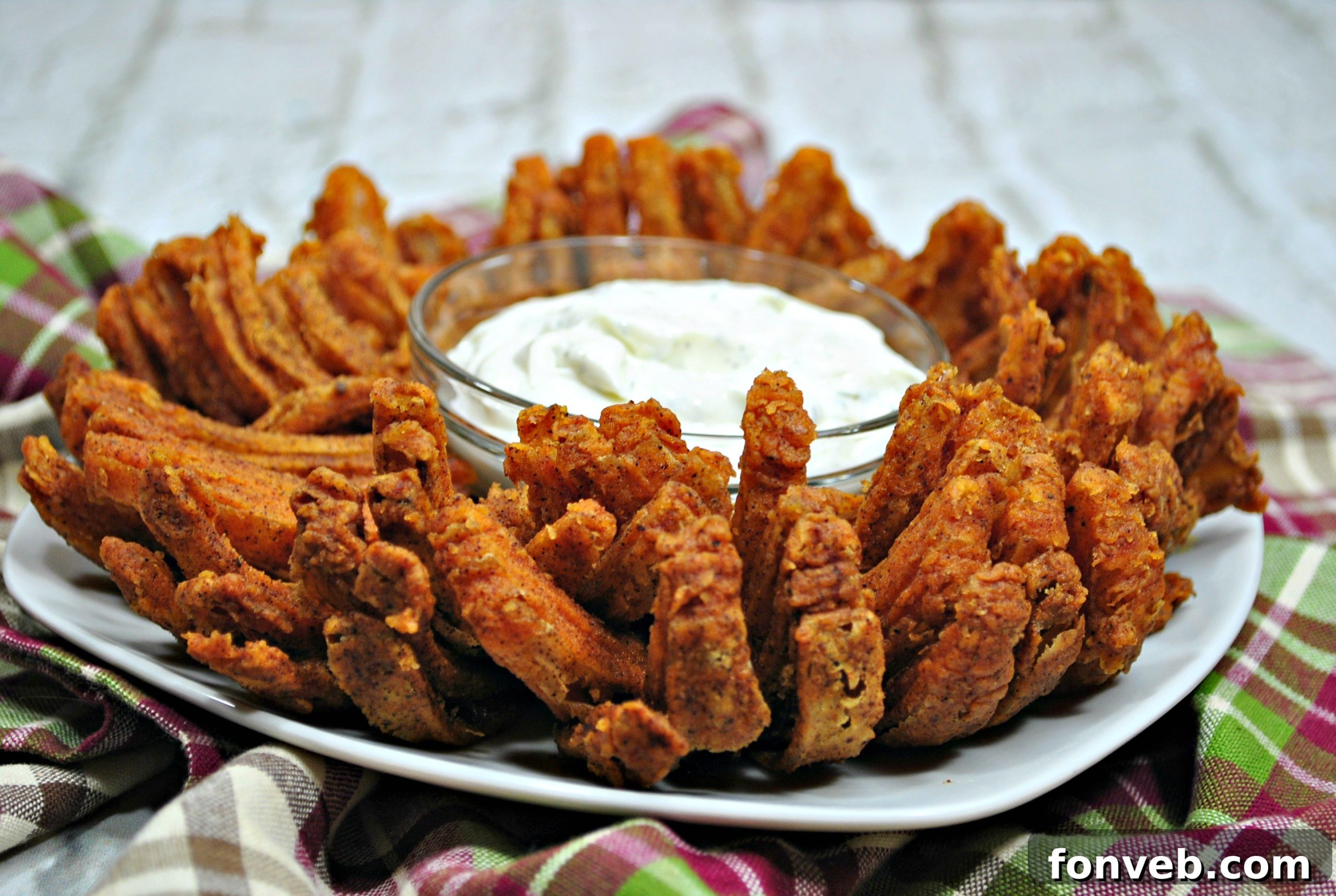 A close-up shot of several individual crispy Bloomin' Onion petals, showcasing their irresistible golden texture and seasoning.