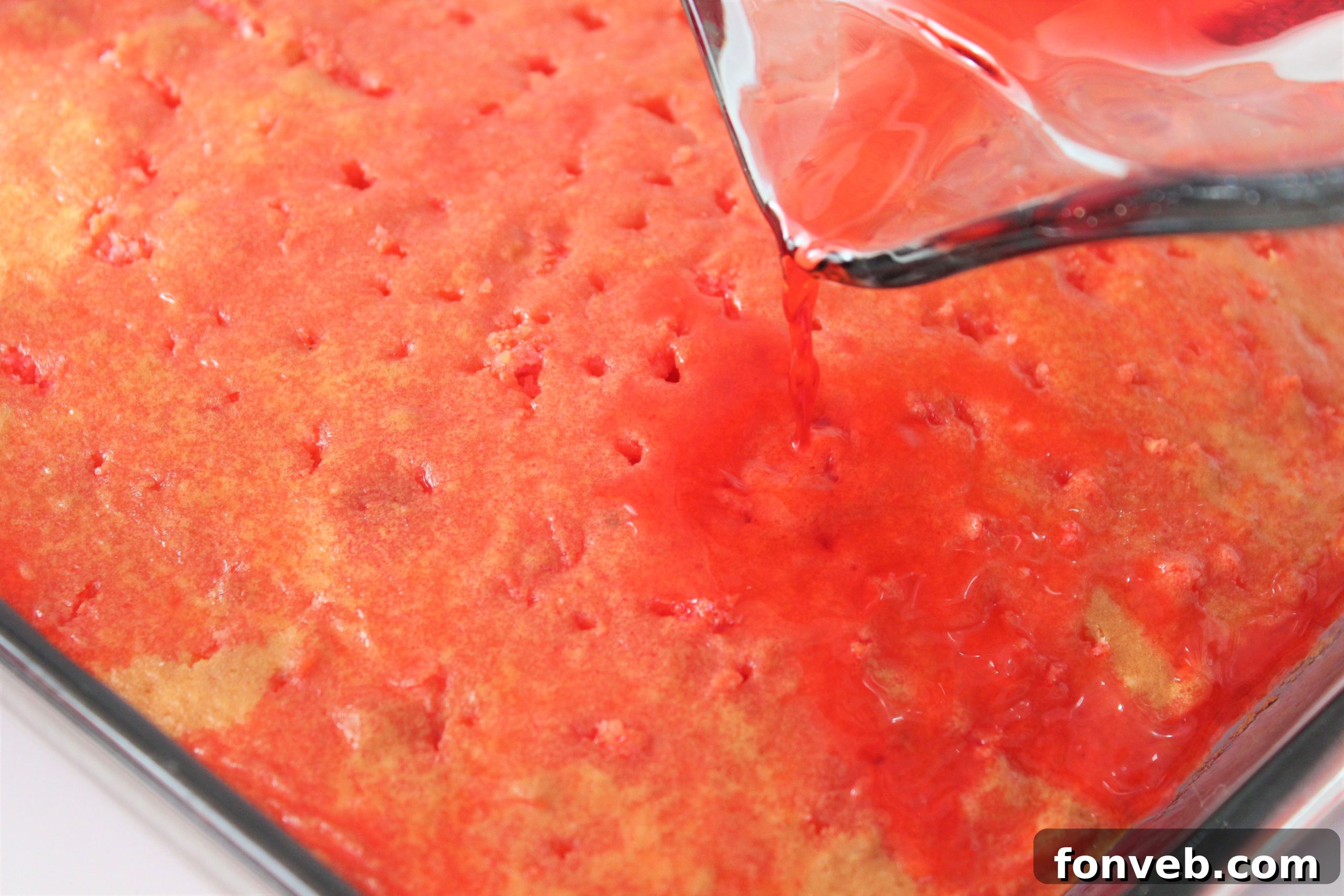 Luscious Strawberry Cheesecake Poke Cake 3 Overhead view of a baked cake, ready for poking