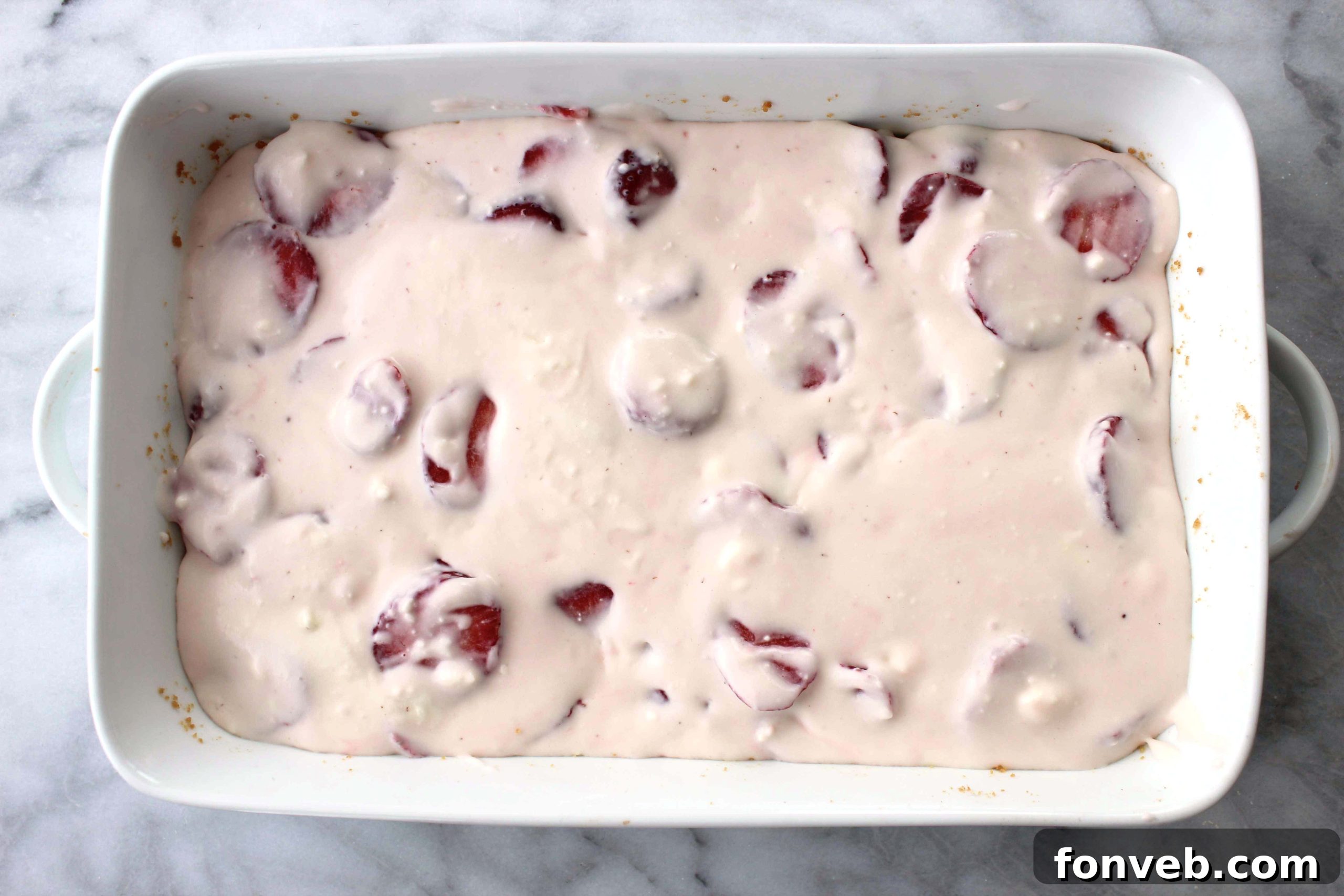 Strawberry Sugar Cookie Dream Bars 3 Overhead view of several Strawberry Dream Sugar Cookie Bars arranged neatly, highlighting the creamy white and red filling.