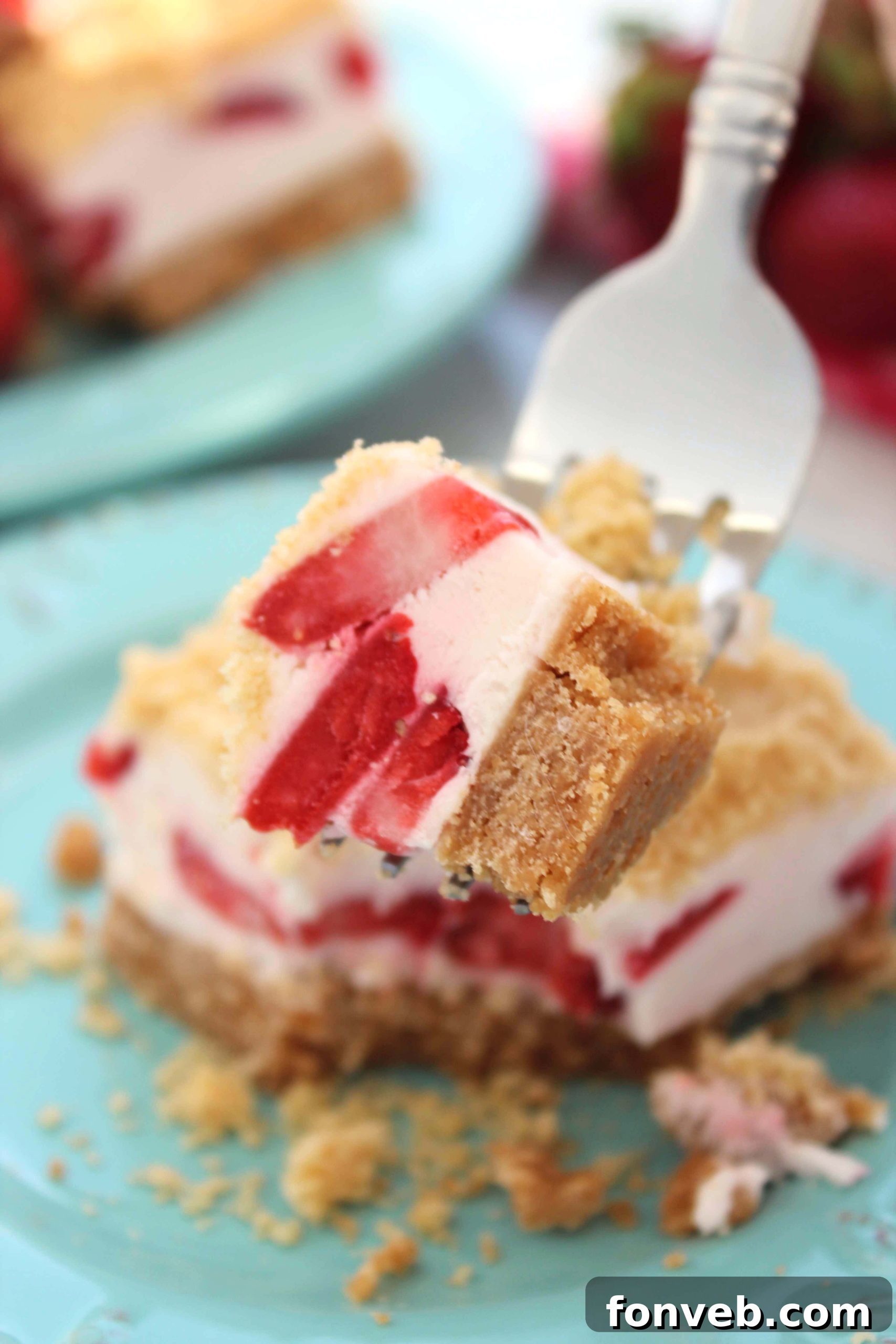 Strawberry Sugar Cookie Dream Bars 6 Close-up of a cut Strawberry Dream Sugar Cookie Bar, highlighting the distinct layers of the cookie crust, creamy filling, and crumb topping.