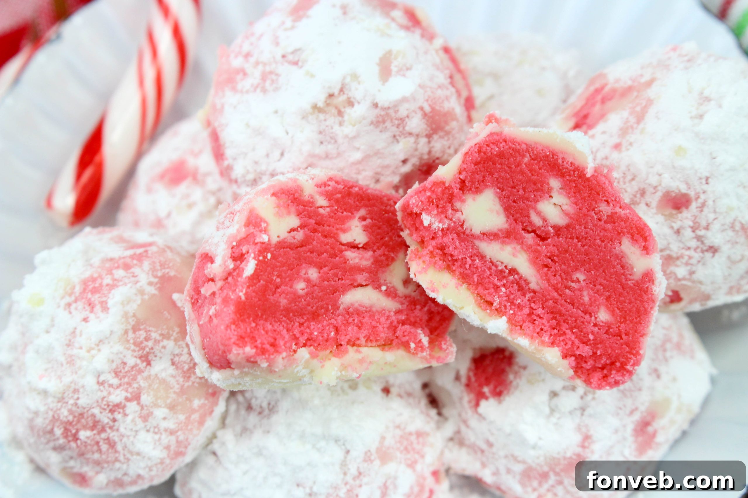 Winter Wonderland Shortbread Snowballs 5 Raw peppermint shortbread snowball cookie dough balls neatly arranged on a parchment-lined baking sheet, ready for the oven.