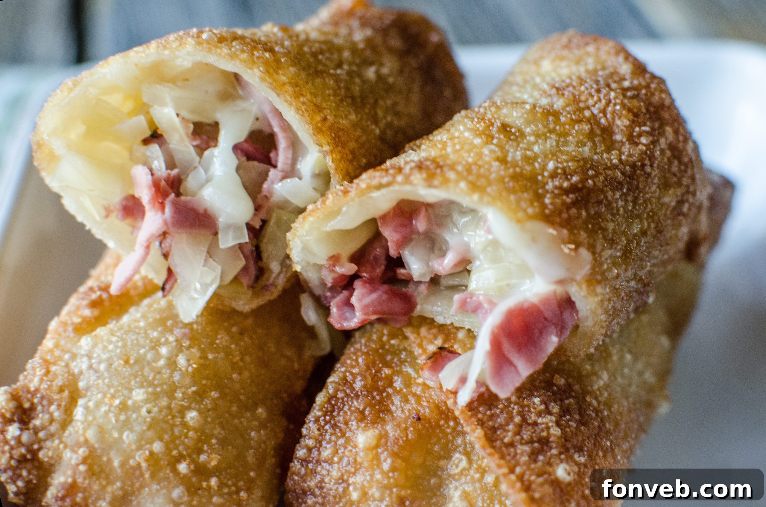 Crispy golden-brown Reuben Egg Rolls piled high on a serving platter, ready to be enjoyed.