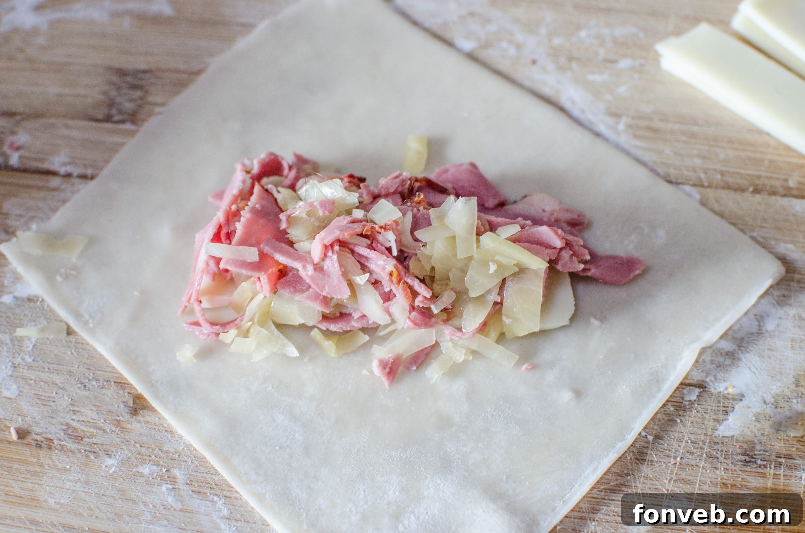 Close-up shot of the savory filling for Reuben Egg Rolls: chopped corned beef or pastrami mixed with sauerkraut.