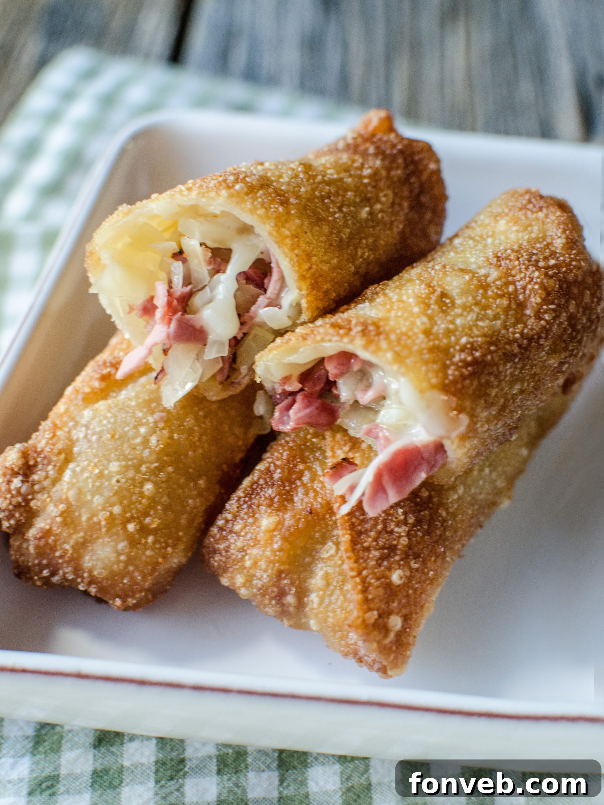A selection of various homemade egg roll creations, including Reuben, cheeseburger, taco, and steak and cheese versions.