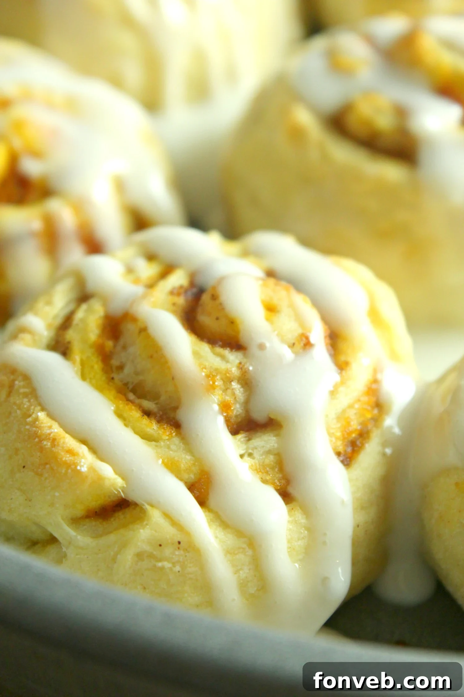 Platter of pumpkin cinnamon rolls with coffee, ready for a cozy fall breakfast or dessert.