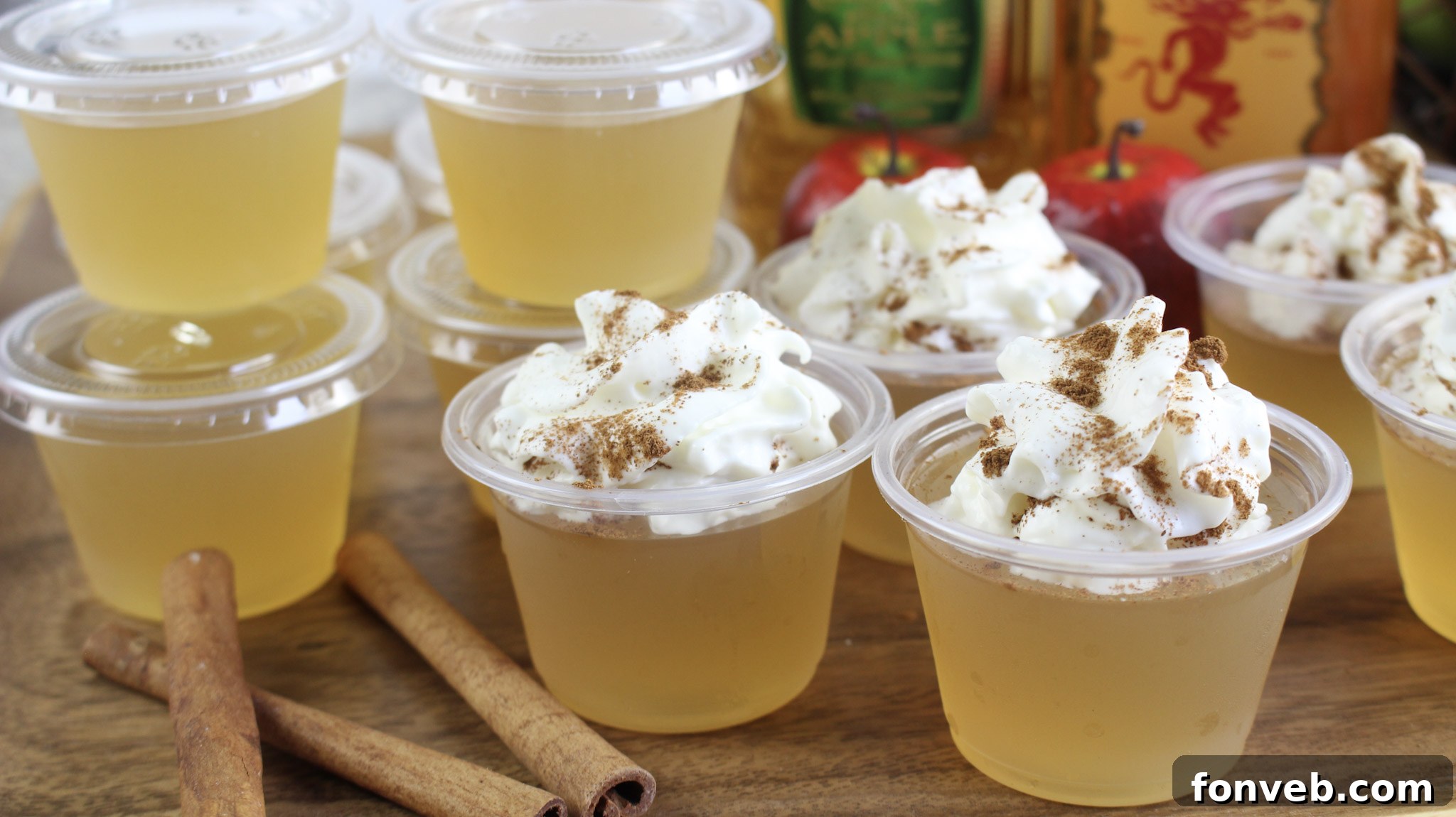 Apple Pie Jello Shots garnished with whipped cream and cinnamon