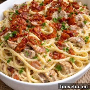 Creamy Bacon Carbonara with Chicken in a big white bowl, a closer shot of the finished dish.