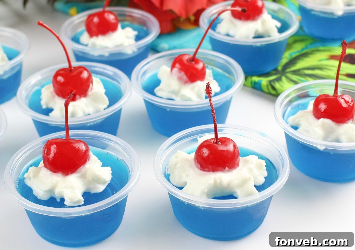 A collection of beautifully crafted Blue Hawaiian Jello Shots, showcasing their inviting blue color and elegant garnishes, ideal for social events.