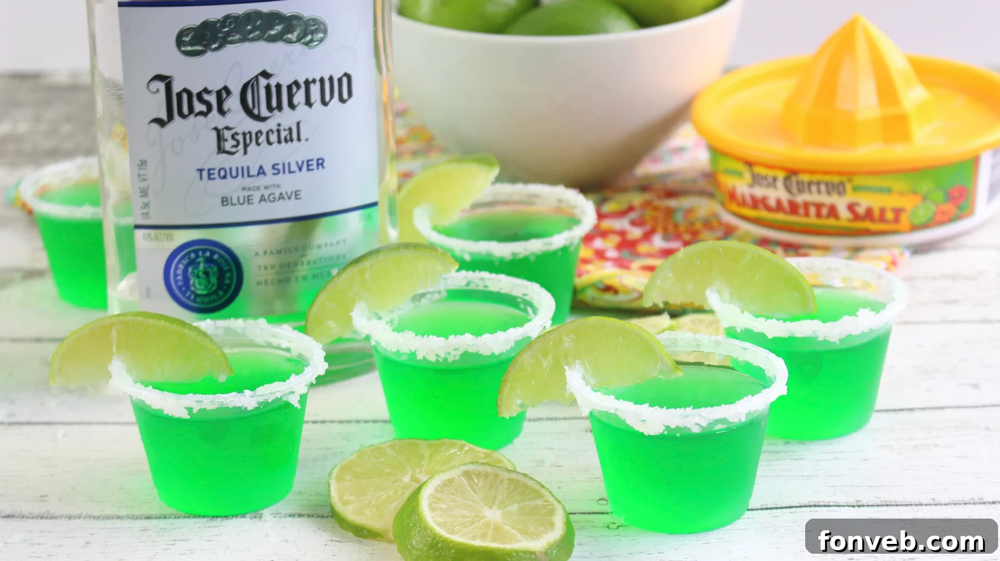 Margarita Jello Shots in various stages of preparation, showing the lime and tequila mixture.