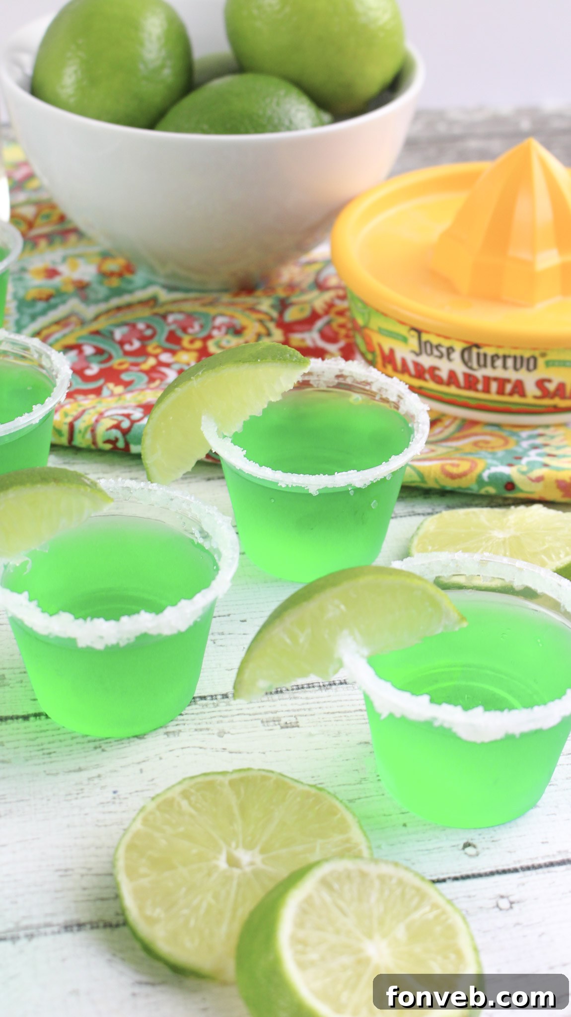 Two Margarita Jello Shots side by side, showcasing the clear green color and lime garnish.