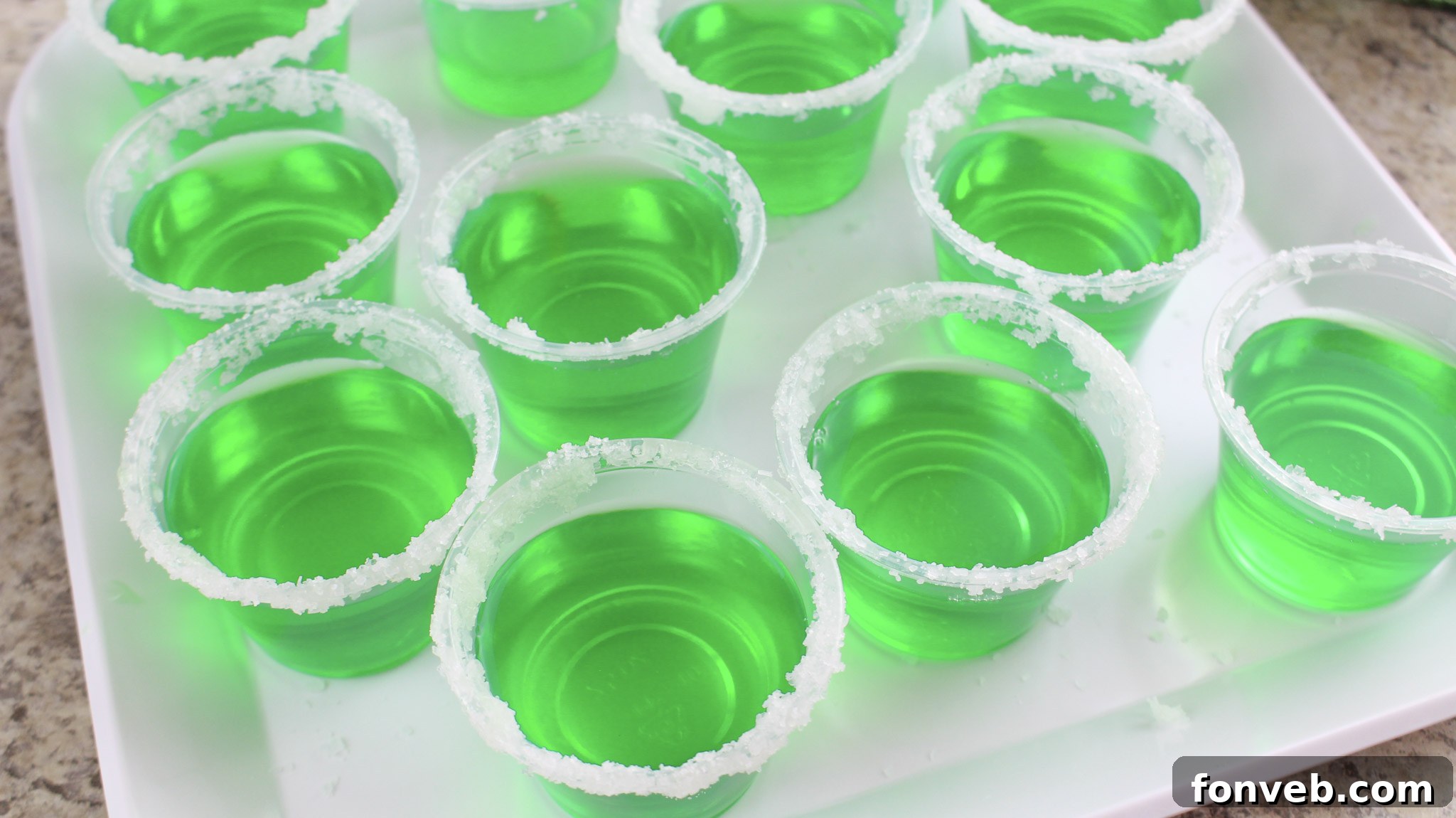 A close-up view of the ingredients for Margarita Jello Shots laid out.