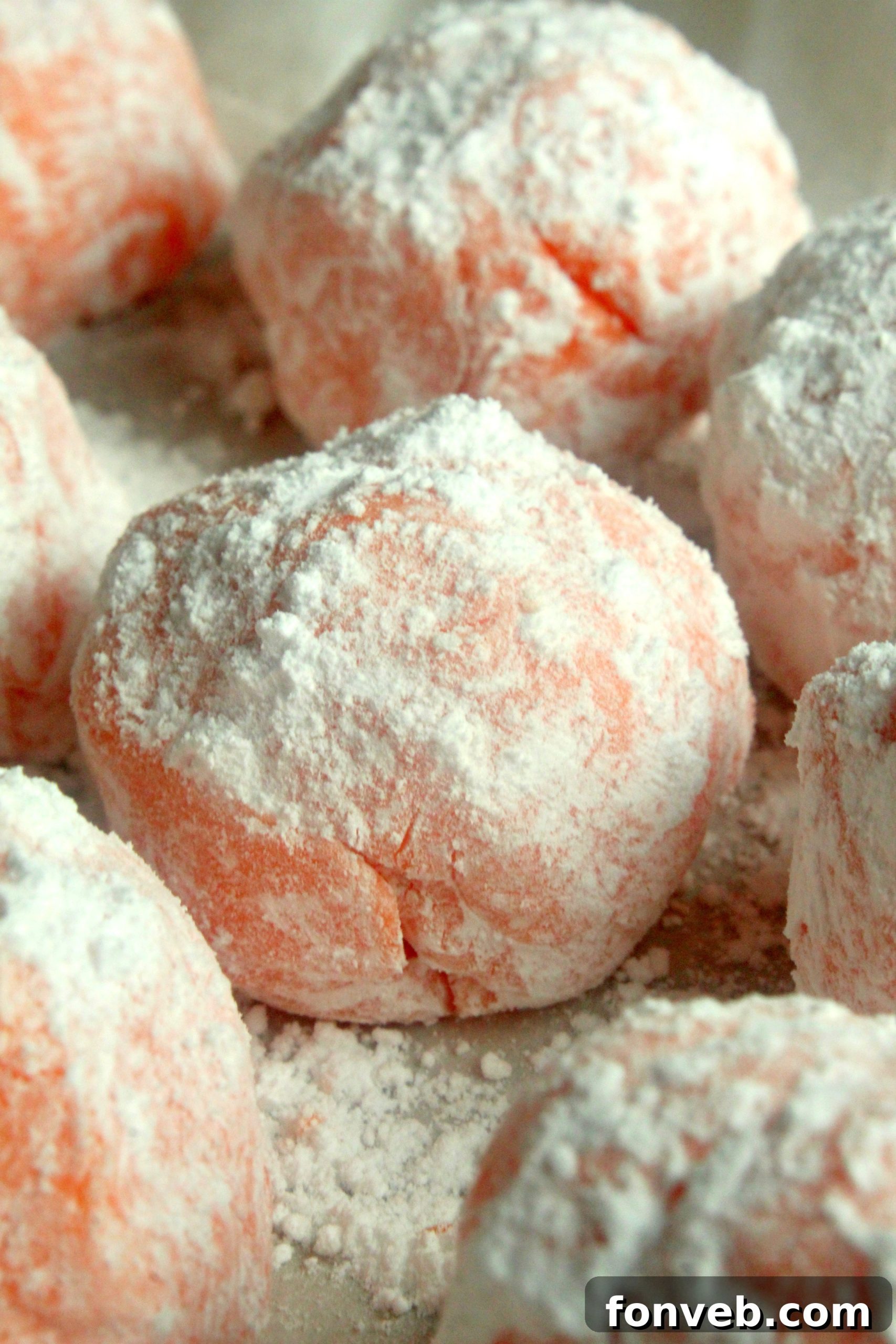 Sunny Orange Creamsicle No Bake Bites 3 Close-up of a single orange creamsicle truffle with a creamy interior and a soft, sweet exterior.