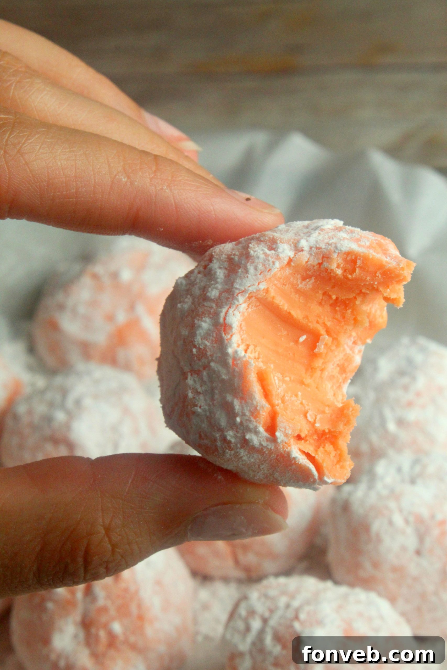 Sunny Orange Creamsicle No Bake Bites 8 Close-up of three orange creamsicle truffles, demonstrating their perfect spherical shape and coating.