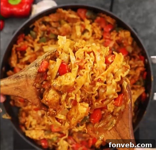 A large skillet holding all the ingredients for the quick and easy chicken fajita pasta