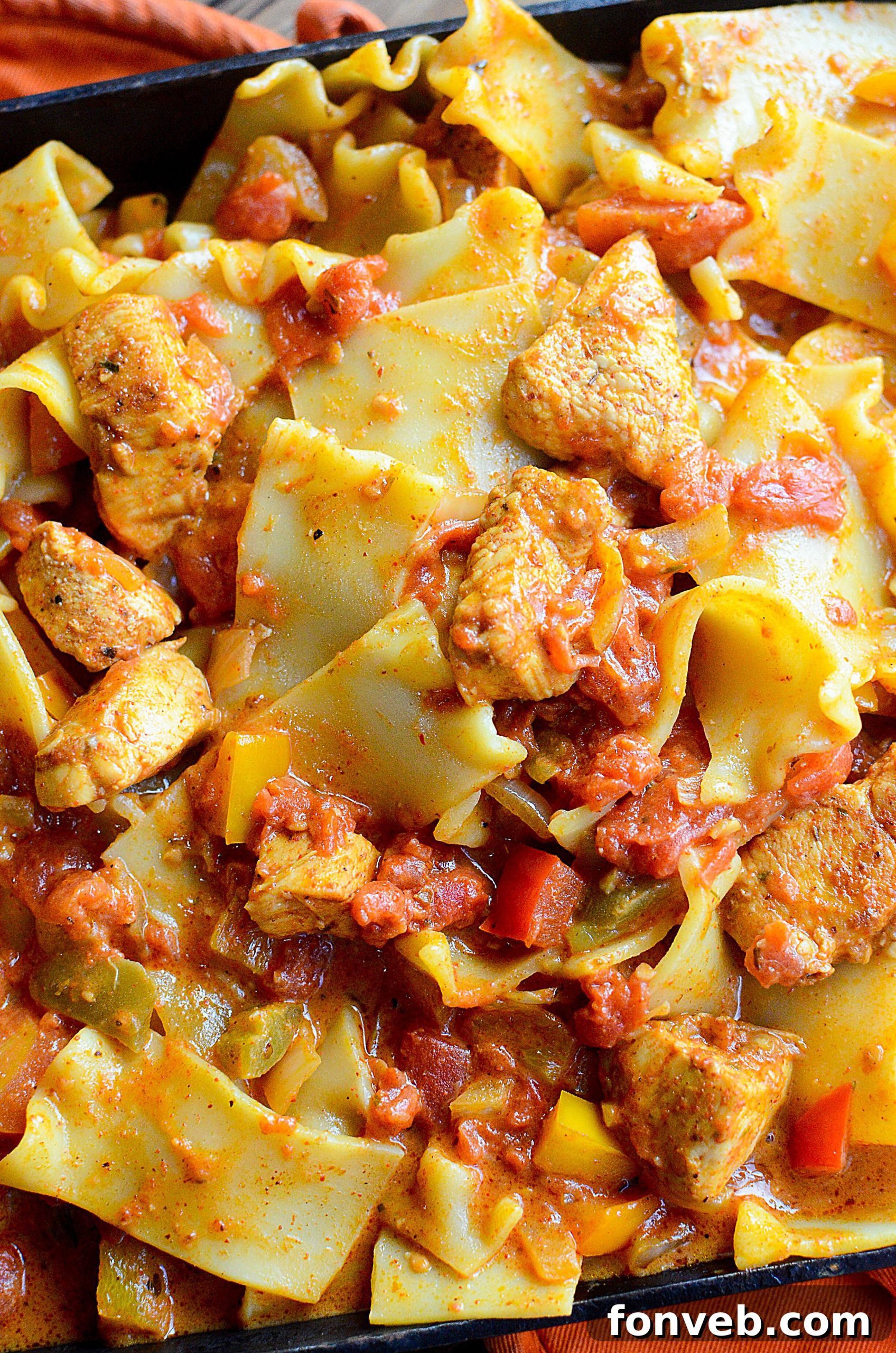 Seasoned chicken pieces cooking in a hot skillet with olive oil