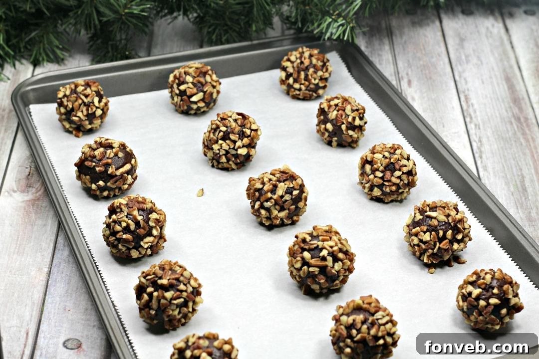 Chewy Turtle Thumbprint Delights 5 Baked Turtle Thumbprint Cookies with indentations, waiting for caramel filling.