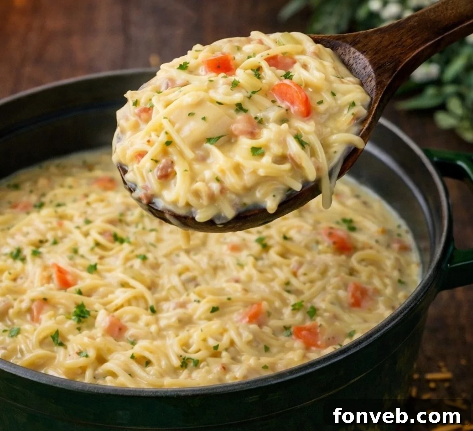 Irresistibly Creamy Chicken Noodle Soup 2 Large pot of Crack Chicken Noodle Soup on a table, with a spoon lifting a scoop of soup and noodles