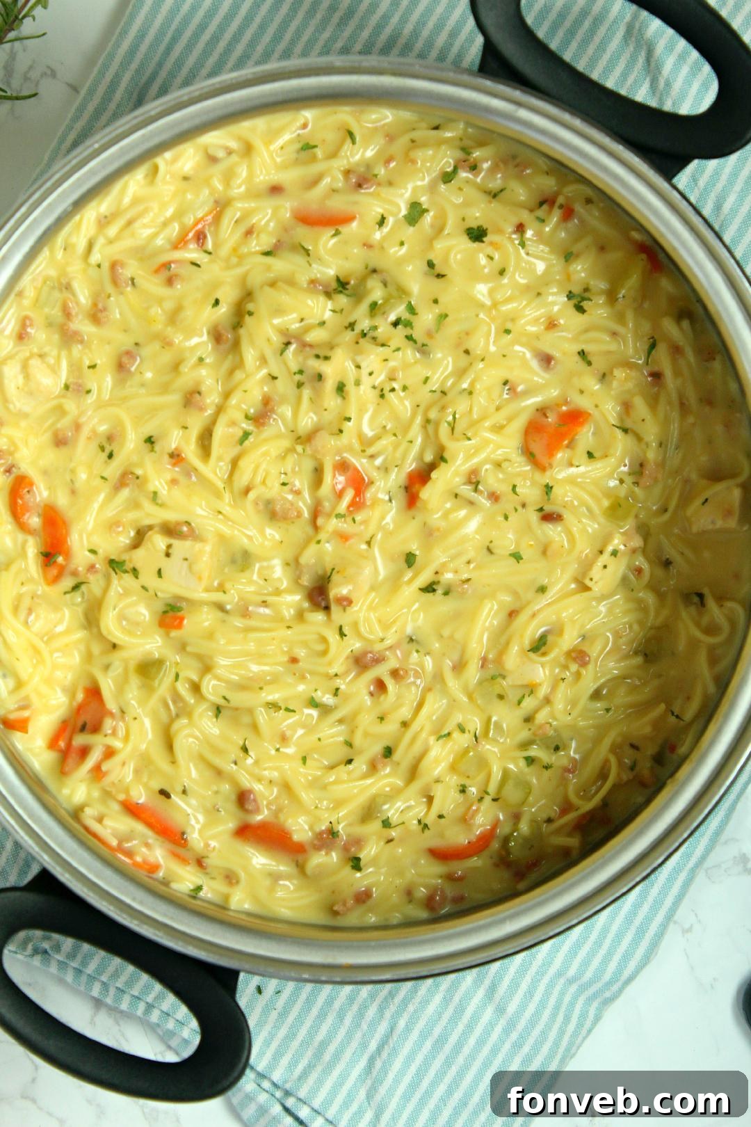 Irresistibly Creamy Chicken Noodle Soup 3 Close-up of Crack Chicken Noodle Soup in a white bowl with a spoon