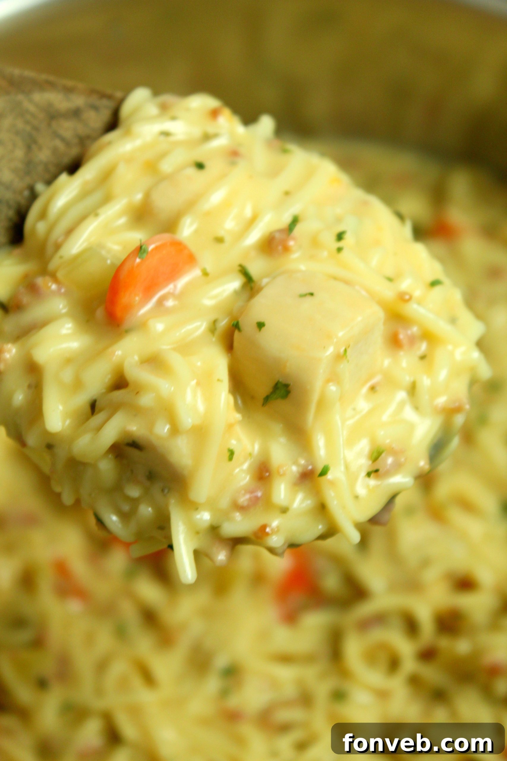 Irresistibly Creamy Chicken Noodle Soup 4 Crack Chicken Noodle Soup simmering in a large pot on a stovetop
