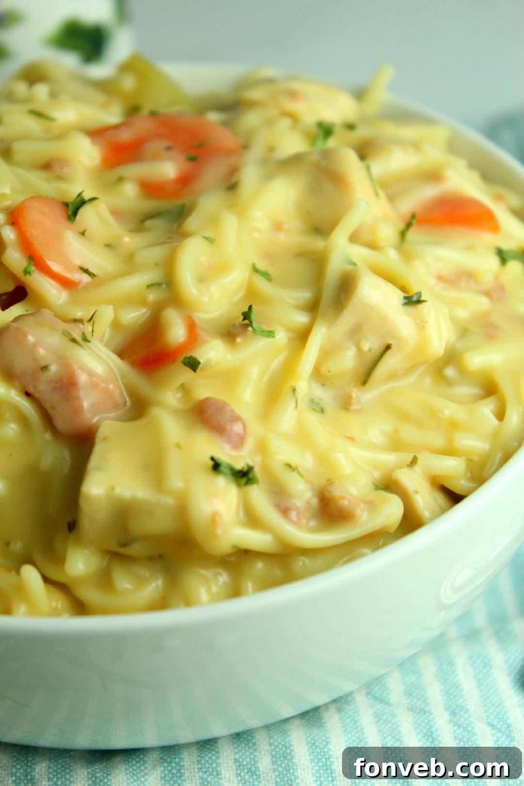 Irresistibly Creamy Chicken Noodle Soup 6 Crack Chicken Noodle Soup simmering in a pot with steam rising, a ladle nearby