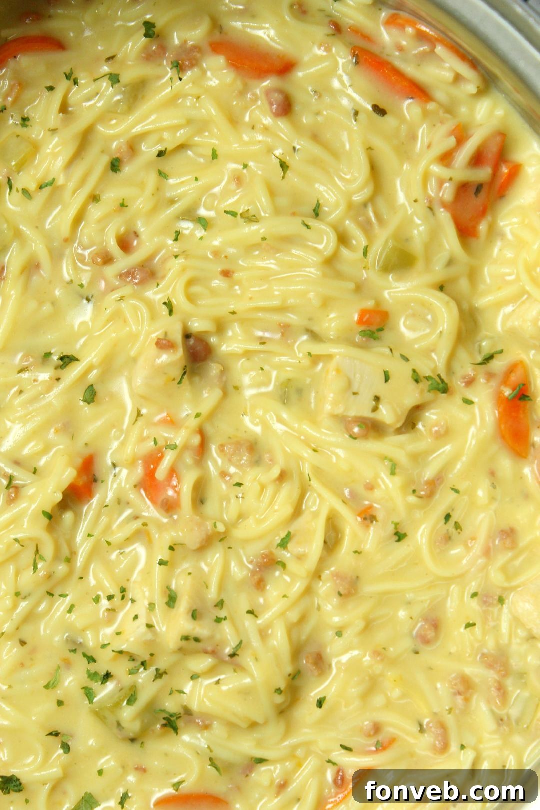 Irresistibly Creamy Chicken Noodle Soup 7 Close-up of Crack Chicken Noodle Soup cooking in a large pot, with noodles visible