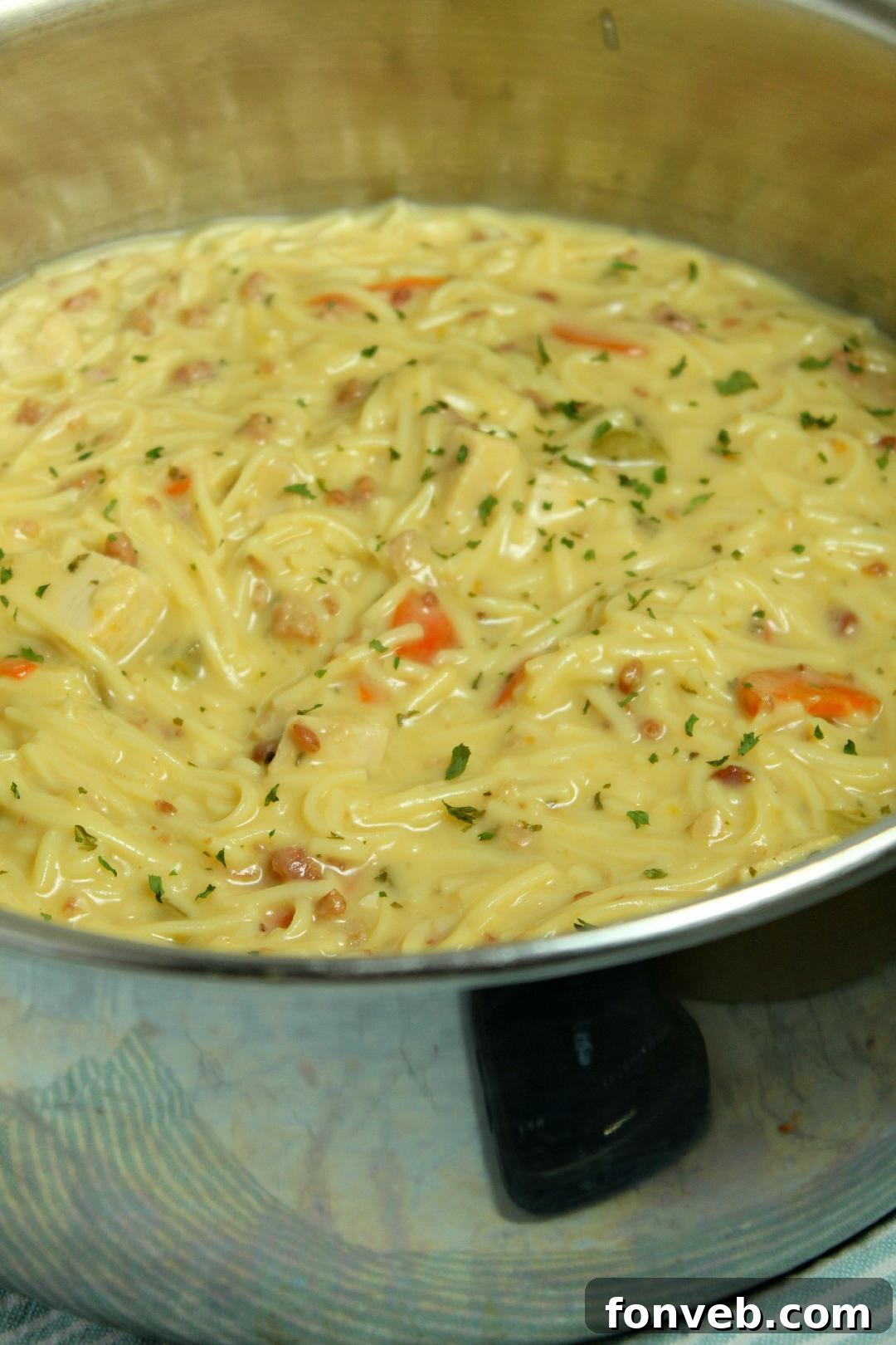 Irresistibly Creamy Chicken Noodle Soup 8 Bowl of Crack Chicken Noodle Soup with fresh parsley garnish on a rustic wooden table