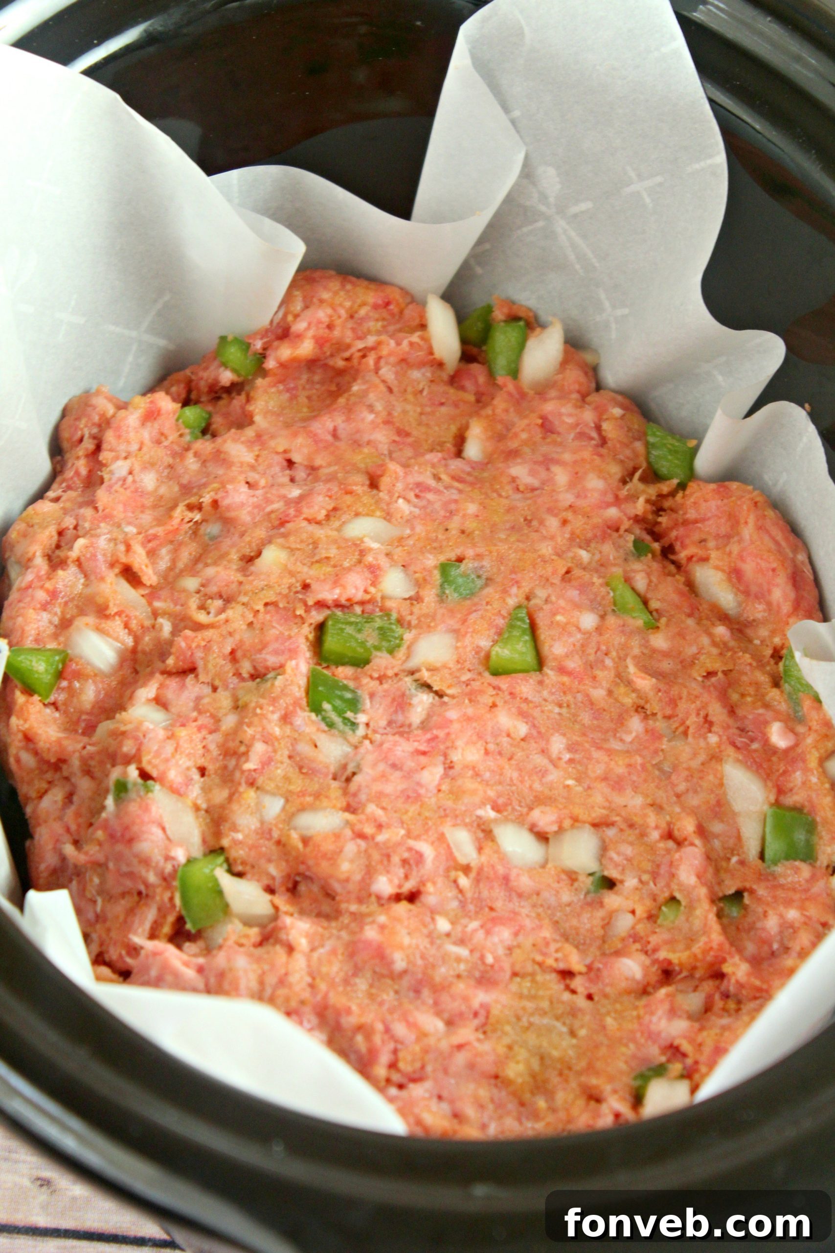 A slice of slow cooker meatloaf on a plate, garnished with fresh herbs.