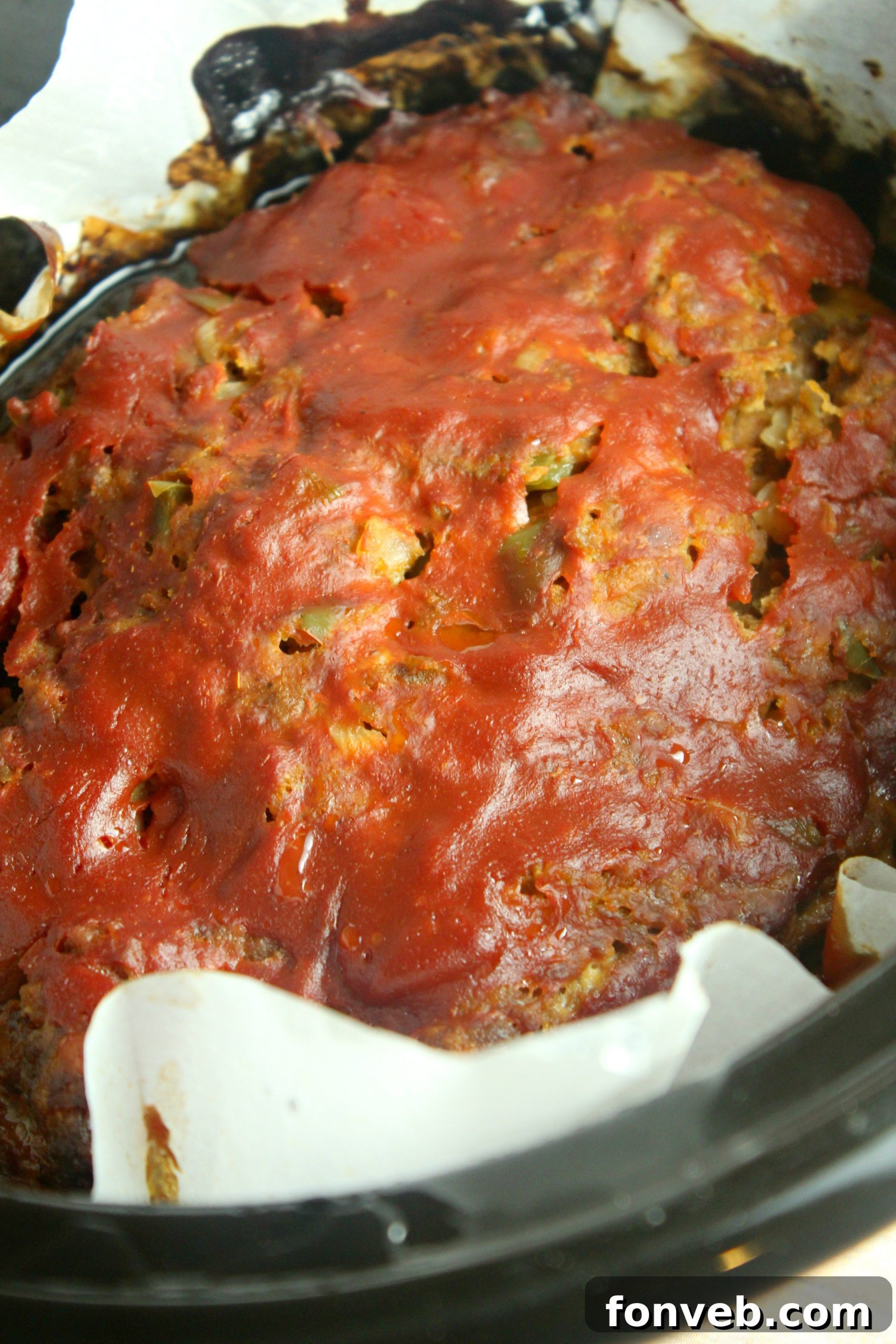 Slow cooker meatloaf served with a side of creamy mashed potatoes and green beans.