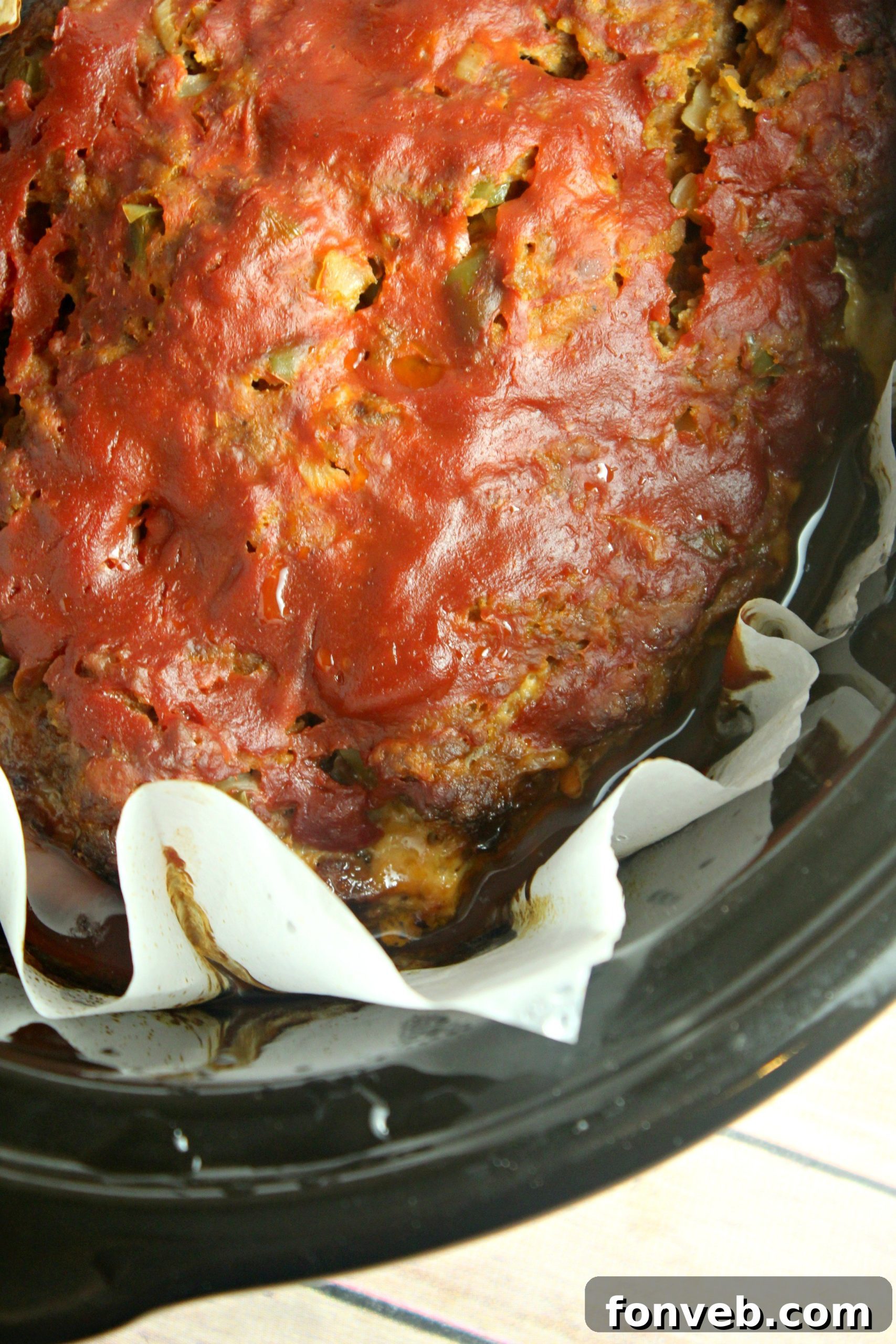 A serving of slow cooker meatloaf with gravy, mashed potatoes, and green beans.