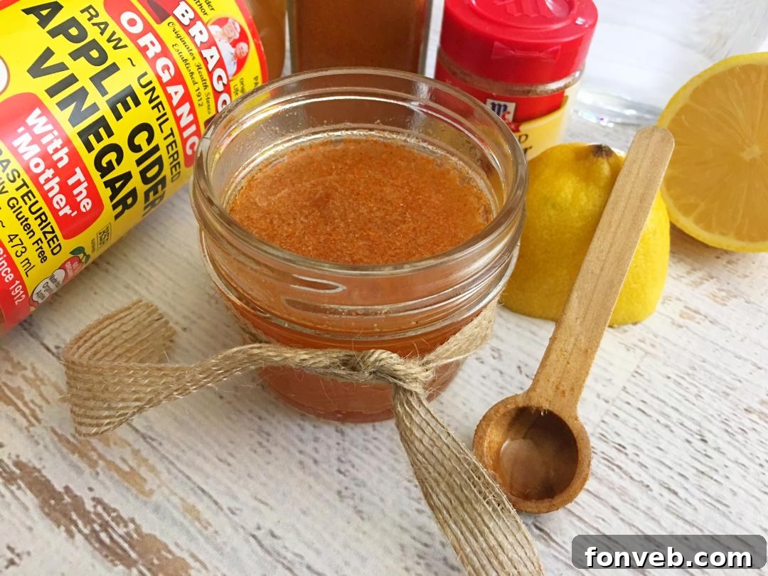 A person taking a spoonful of homemade cough syrup, showing the thick, golden consistency.