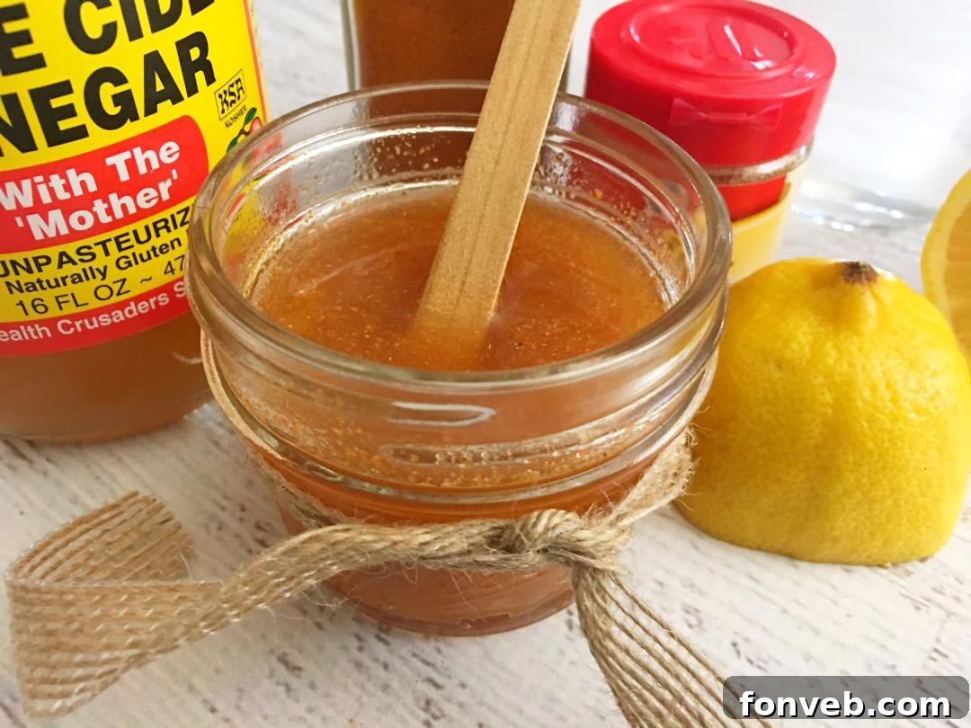 The finished homemade cough syrup in a small glass bottle, ready for use.