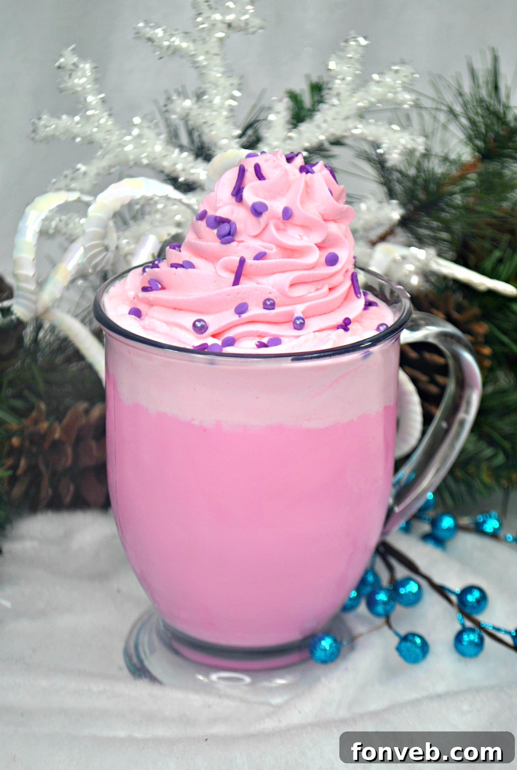 Close-up of Sugar Plum White Hot Chocolate with Cotton Candy Whipped Cream, showing its vibrant colors and delicious texture.