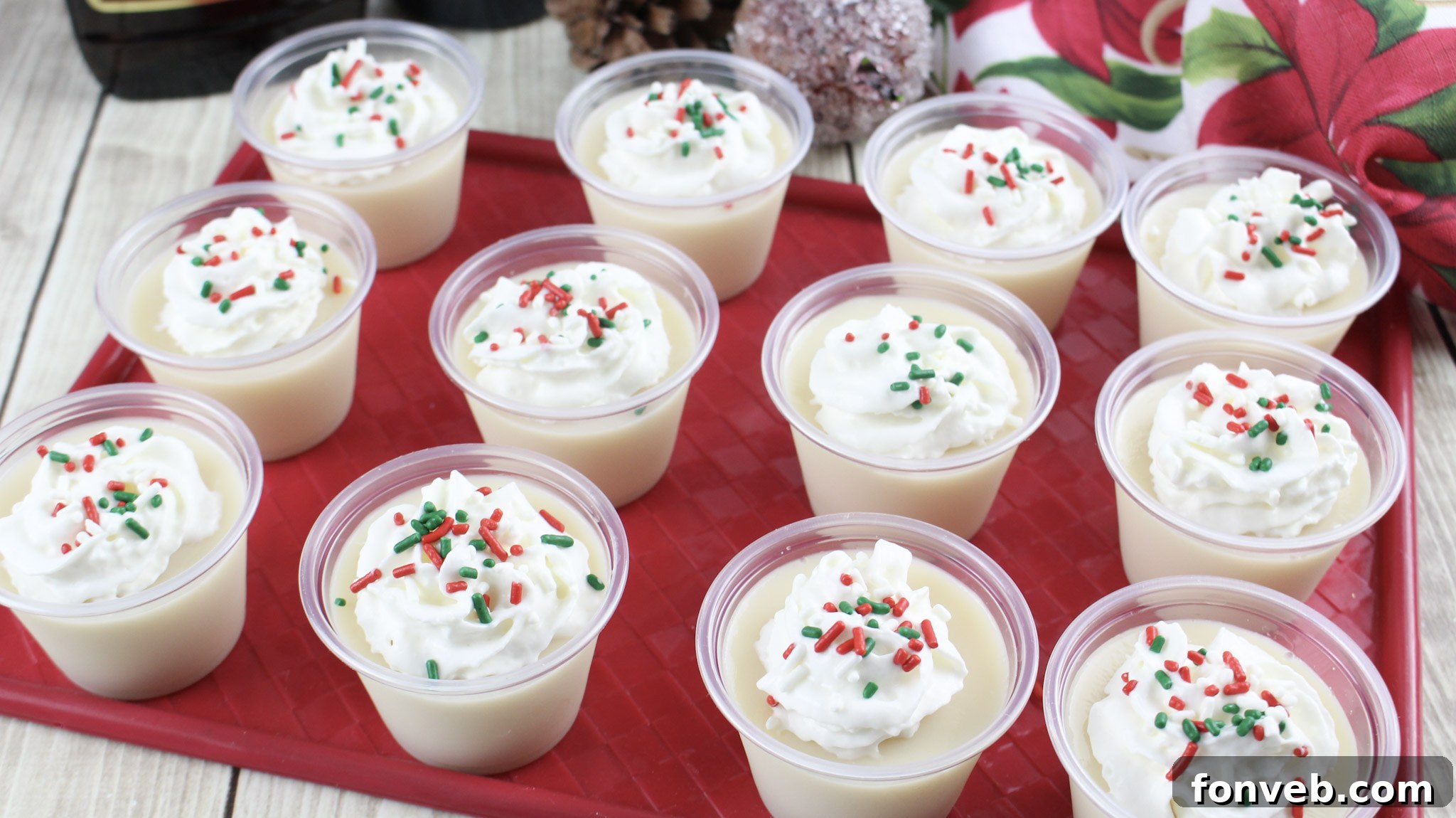Close-up view of two Christmas Sugar Cookie Jello Shots, with focus on the rich texture and garnishes.