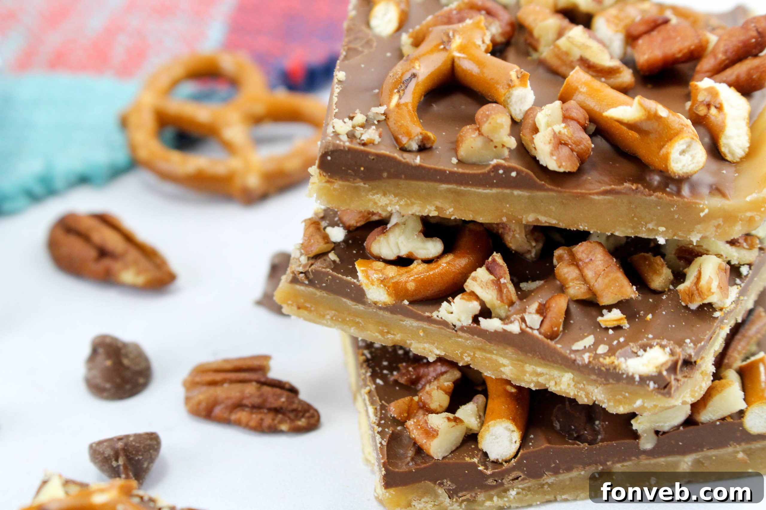 A close-up of a few pieces of the cracker toffee, highlighting the delicious layers of caramel and chocolate with the crunchy toppings.