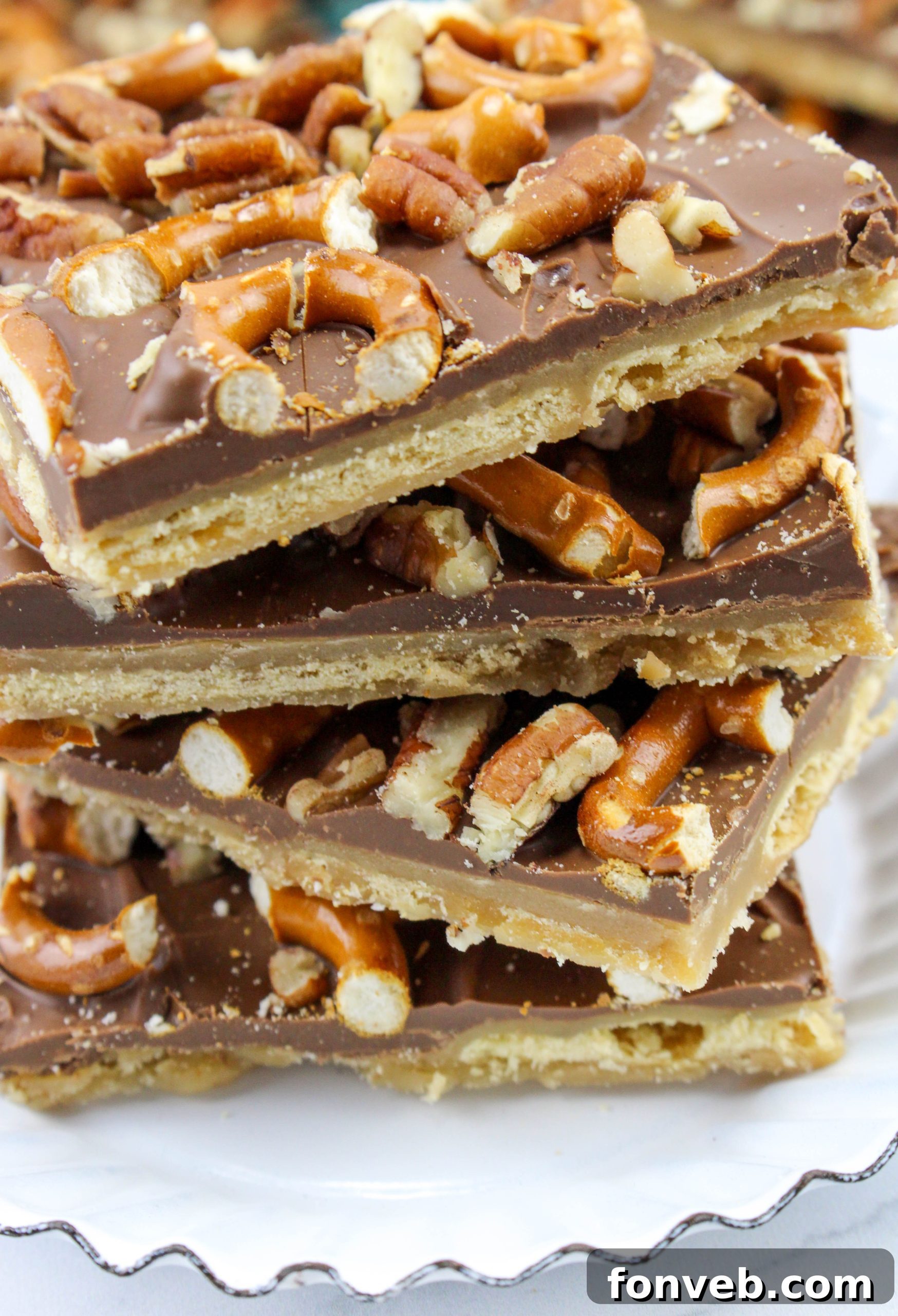 Another angle of the finished Saltine Cracker Toffee, emphasizing the rich chocolate and generous nut and pretzel toppings.