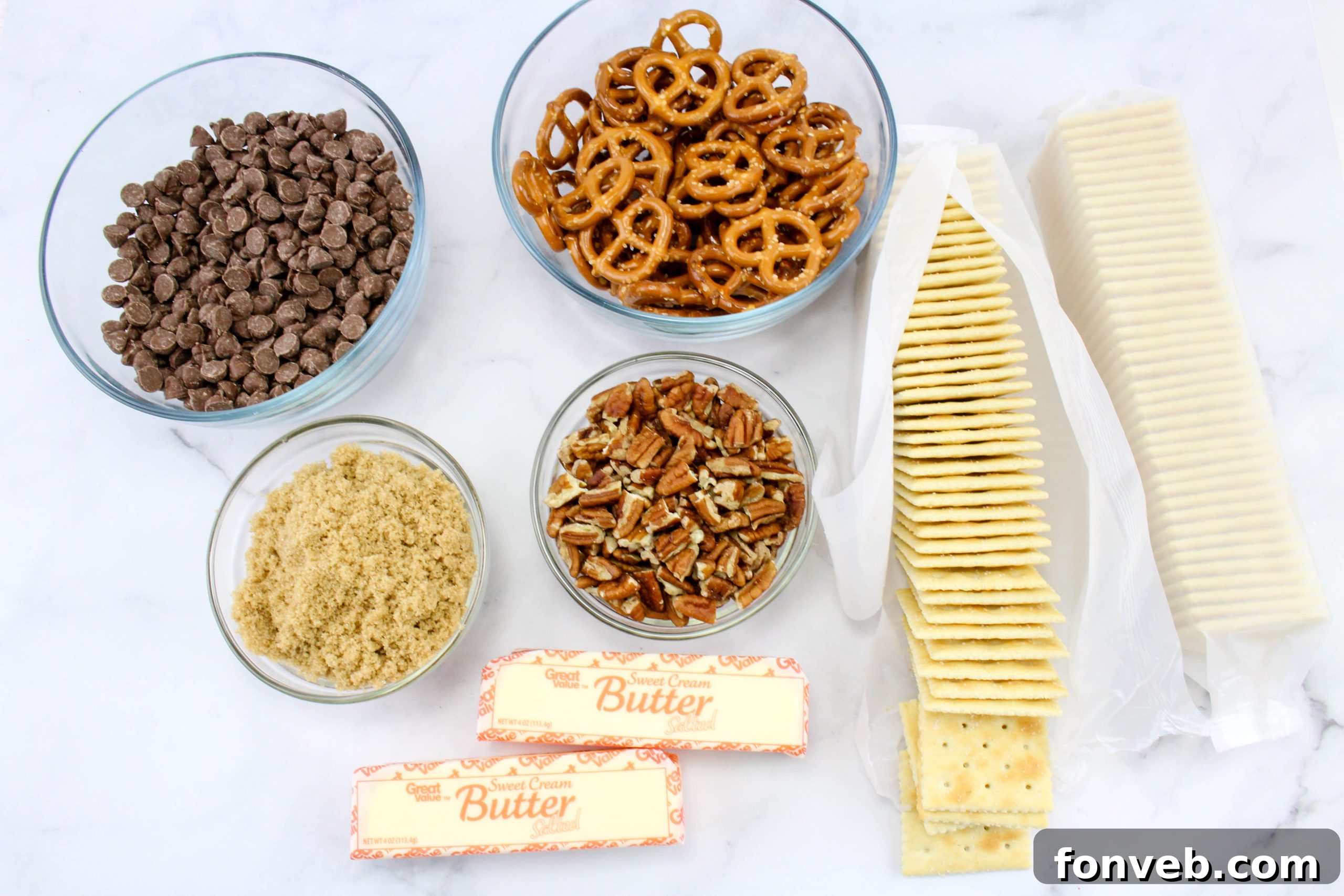 Close-up of Saltine Cracker Toffee on a baking sheet, showing the base of crackers covered in bubbly caramel, ready for chocolate.