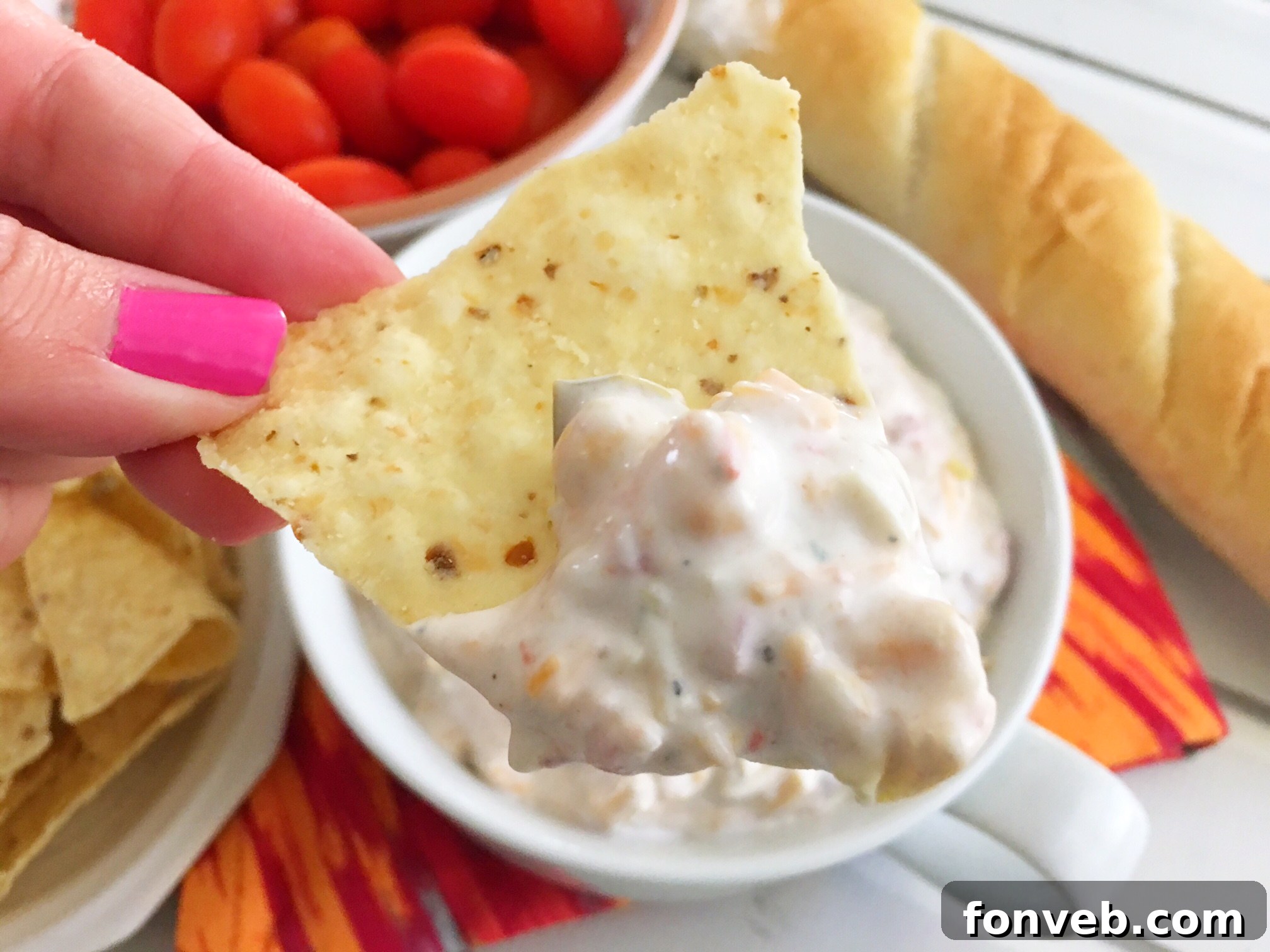 Vibrant 5-Ingredient Fiesta Dip served in a white bowl with colorful tortilla chips