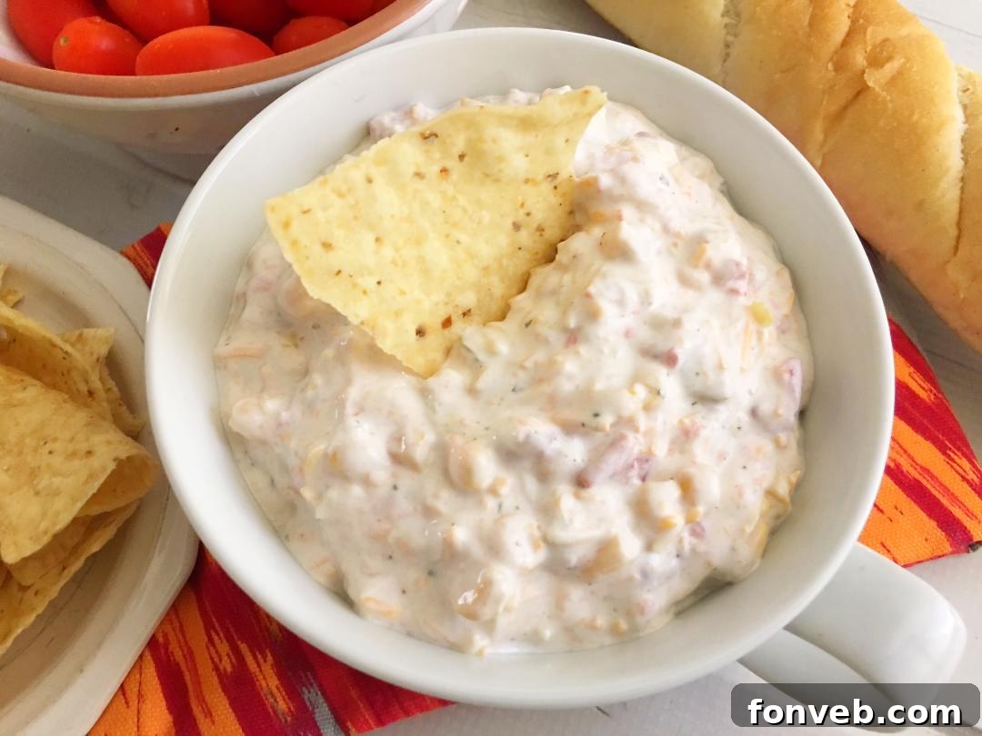 A bowl of Fiesta Dip artfully garnished, ready for a party spread