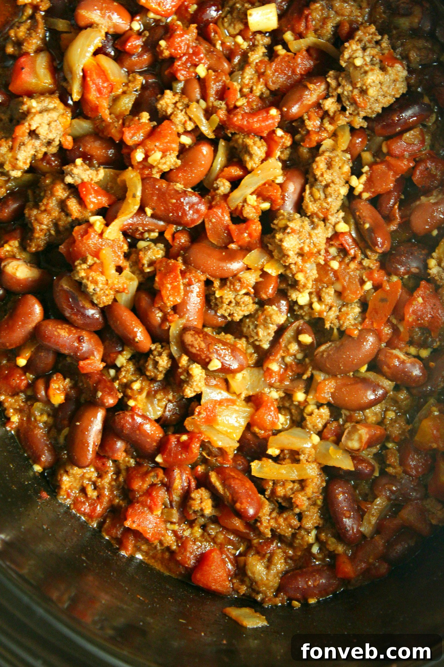 Ultimate Homestyle Slow Cooker Chili 5 Hearty slow cooker chili garnished with fresh herbs and a dollop of sour cream.