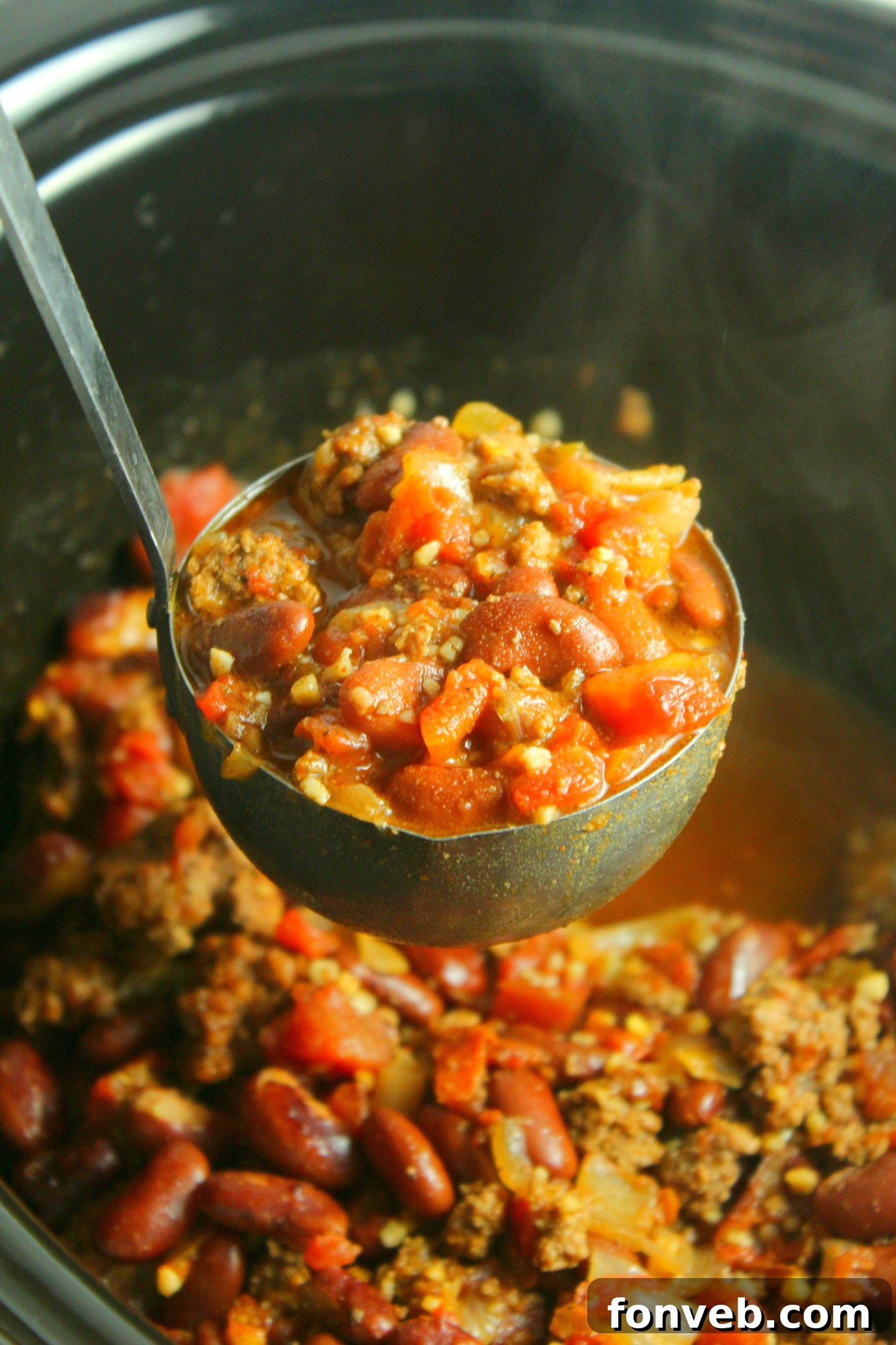Ultimate Homestyle Slow Cooker Chili 6 Creamy sour cream melting into a hot bowl of homemade beef chili.