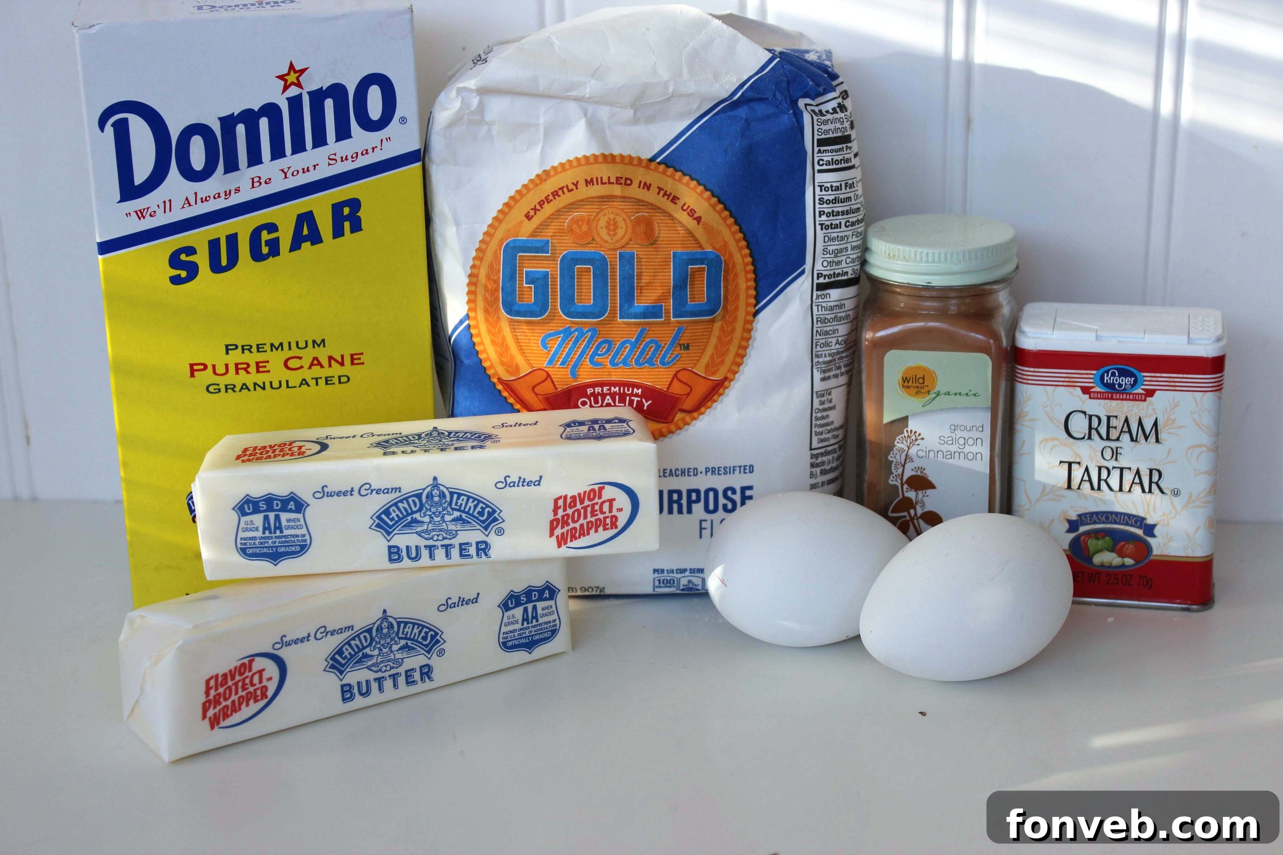 A curated collection of all the fresh ingredients needed to bake classic snickerdoodle cookies, including flour, sugar, butter, and spices.