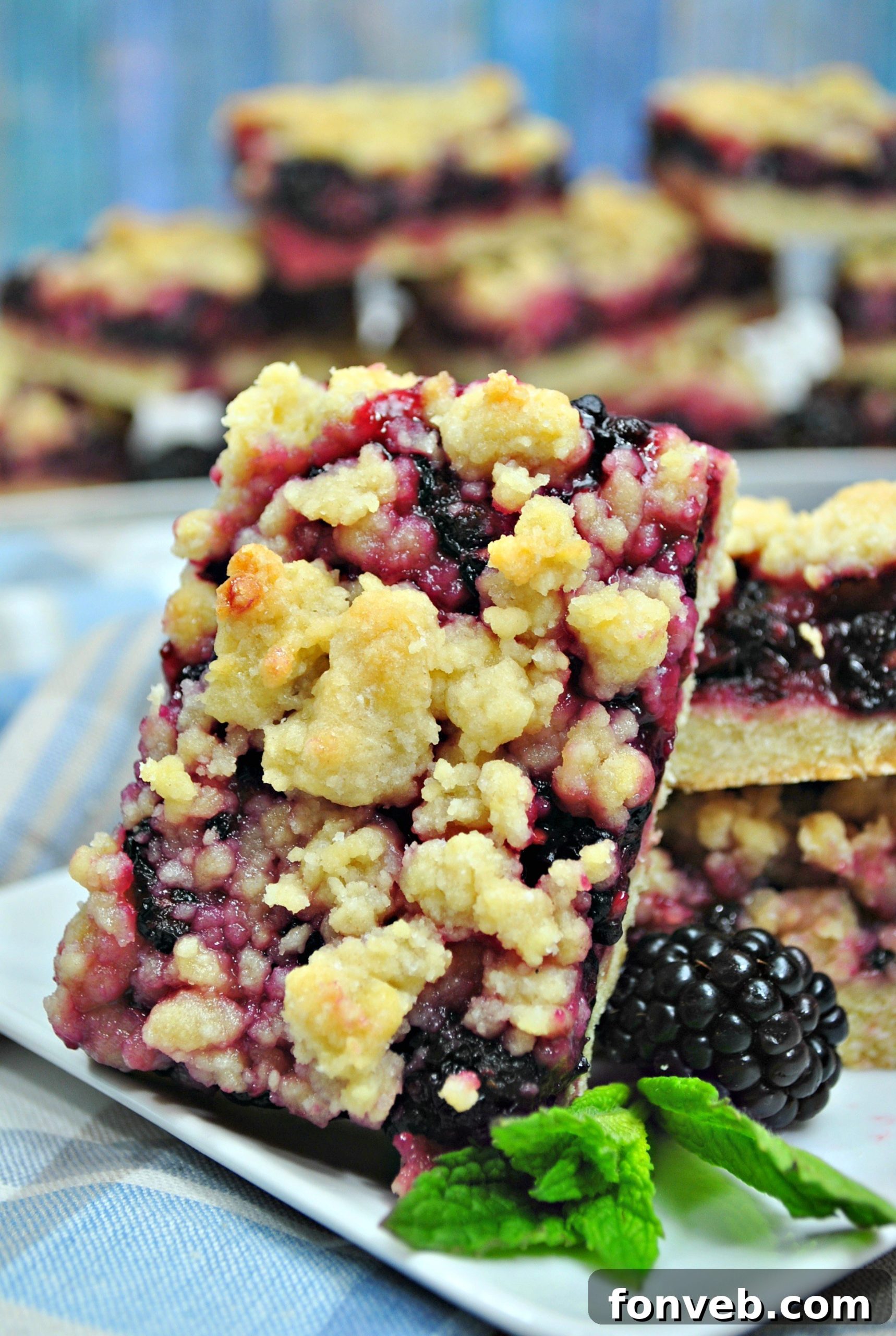 Jammy Blackberry Crumble Slices 7 A slice of Blackberry Pie Crumble Bar, showing the thick layer of blackberry filling.