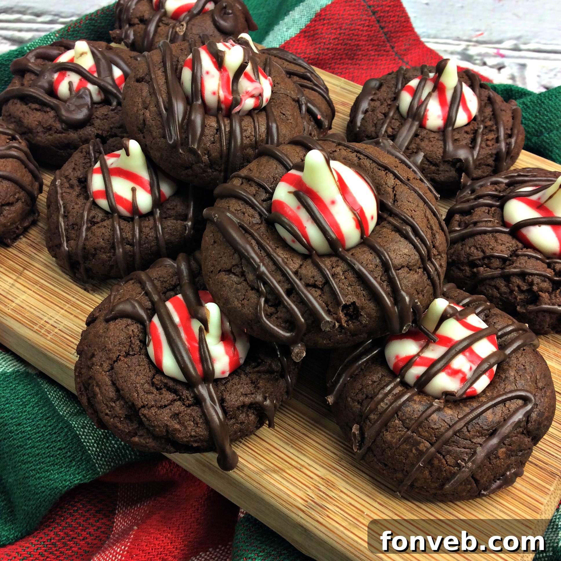 Beautifully arranged Chocolate Peppermint Thumbprint Cookies on a festive plate, showcasing their dark chocolate base and red-and-white peppermint kiss centers.