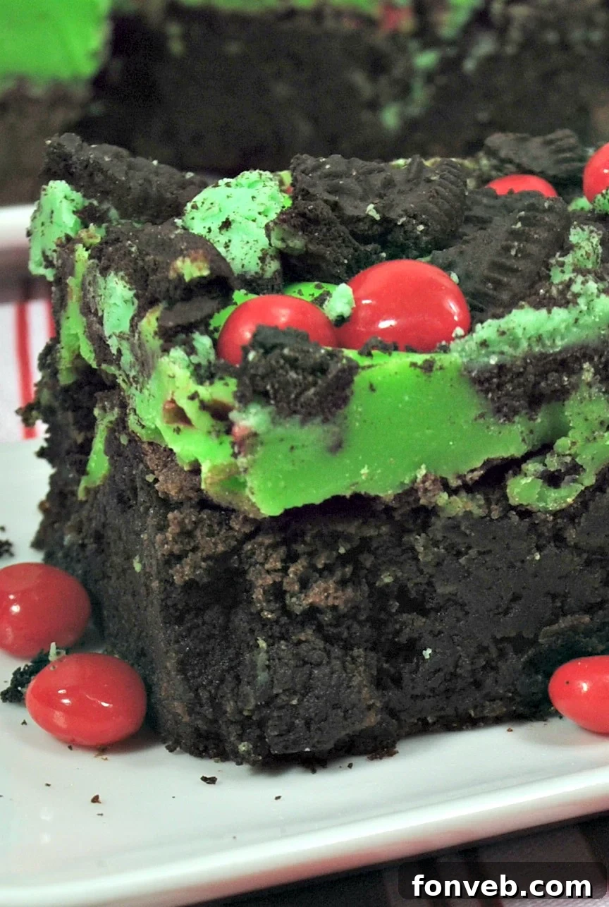 Close-up of a Grinch Brownie showing the green ganache and red candy heart.