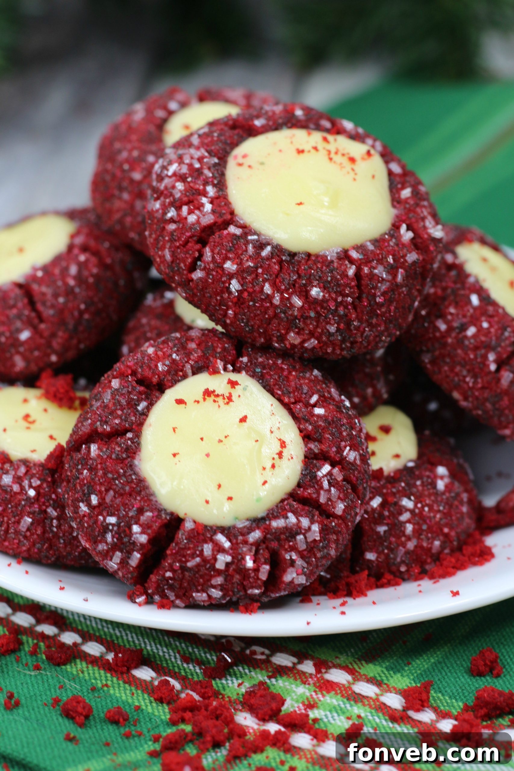 A close-up shot of a single Red Velvet Cheesecake Thumbprint Cookie on a pristine white surface