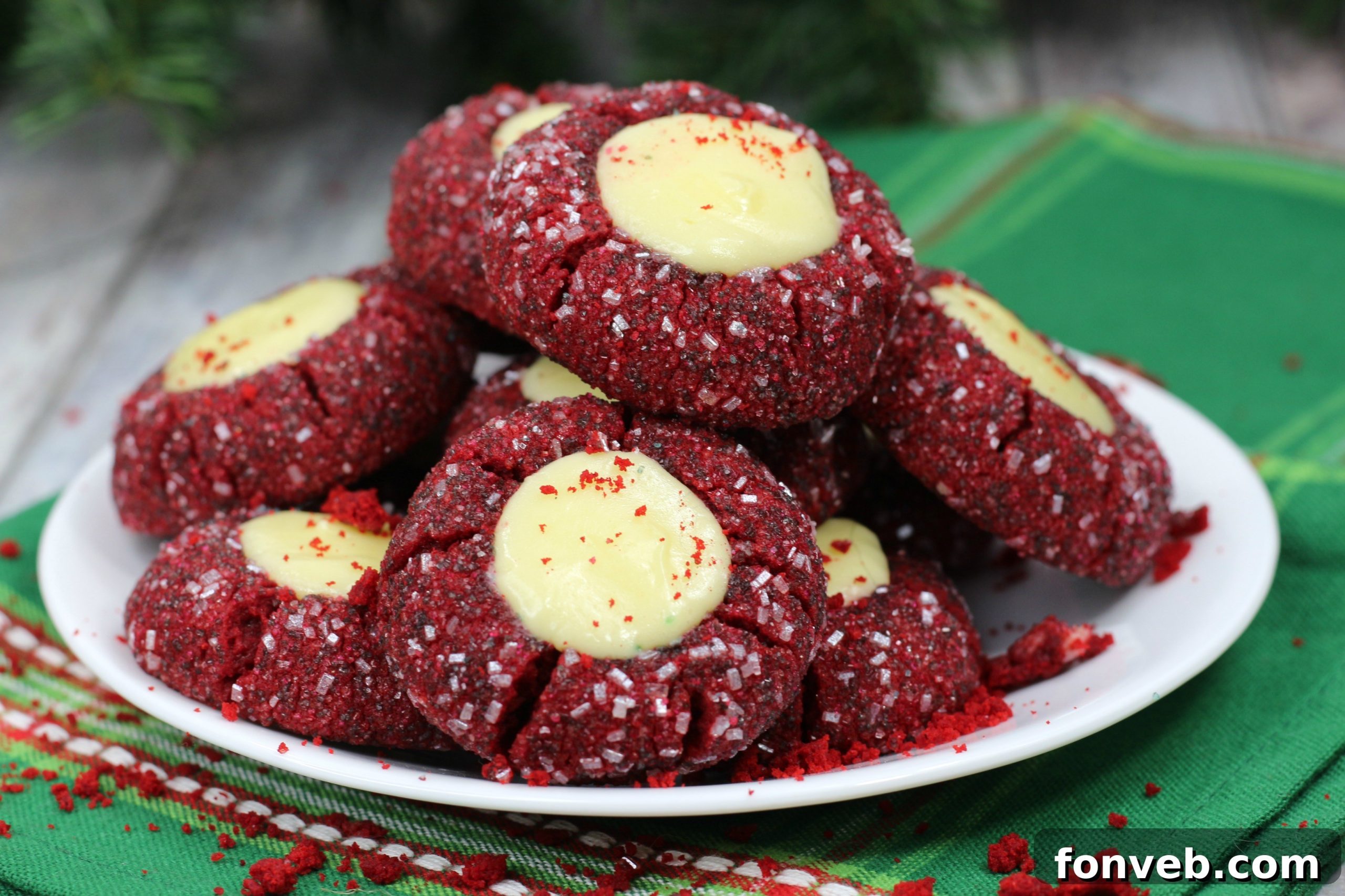 Red Velvet Cheesecake Cookies arranged on a cooling rack, glistening with a hint of sanding sugar